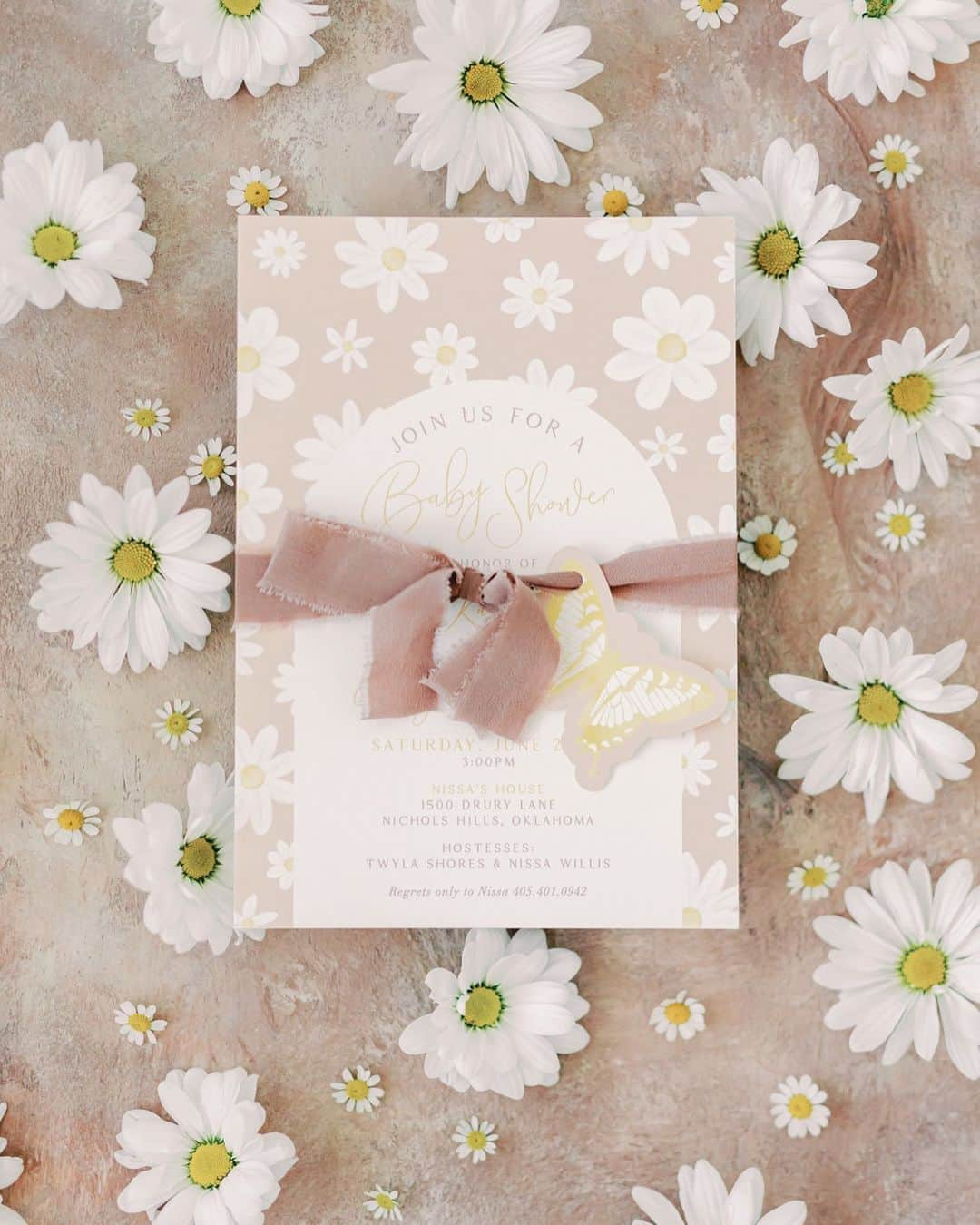 Ceci Johnsonのインスタグラム：「BABY SHOWER | Presenting our couture invitation for Kaytlin’s baby shower. The design incorporates lovely daisy watercolors printed on 4-ply luxe paper, inviting guests to partake in the blooming journey of love and anticipation. Adorned with a soft blush ribbon, it carries a delicate paper butterfly, symbolizing the grace and transformation that a new life brings.  #CeciCouture ⠀⠀⠀⠀⠀⠀⠀⠀⠀ CREATIVE PARTNERS Invitation: @cecinewyork Photographer: @kelseylanaephotography  Florals: @poppylanedesign  Cookies: @meant2bbakery  ⠀⠀⠀⠀⠀⠀⠀⠀⠀ #cecinewyork  #coutureinvitation  #babyshowerinvitation  #daisyinvitation #beautifulstationery」