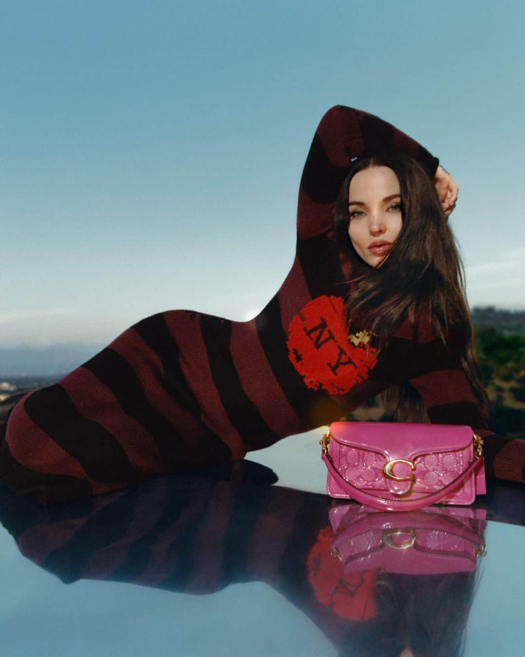コーチのインスタグラム：「No one shines quite like #DoveCameron. But this patent Tabby 20 comes close. 💖  #WearYourShine. Our Fall 2023 story is a call to resist your inner critic and show your most confident self.  Photographer: @joshuawoods Stylist: @gabriellak_j Production design: Christian Stone  #CourageToBeReal #CoachNY」