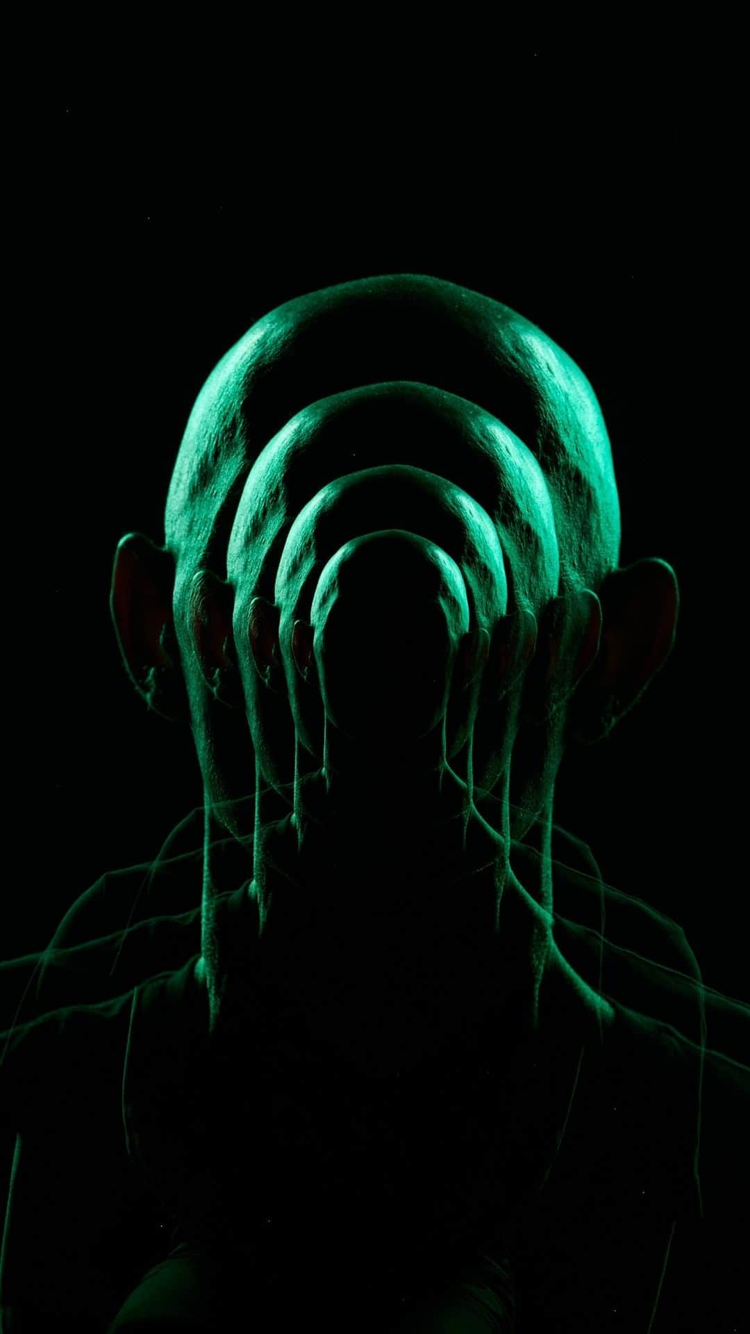 ナショナルジオグラフィックのインスタグラム：「Words by Becky Hale @beckythale | In order for this conceptual image to illustrate the idea of brainless clones for the National Geographic “Gory Details” bookazine, I used an unusual technique, all in-camera. We knew we needed the perfect head and immediately thought of our staff artist, Fernando G. Baptista. I didn’t want his face to be recognizable, so I rim-lit him with moody green strobes. First, I zoomed in all the way on his head, then opened the shutter and fired the strobe. Without closing the shutter, I zoomed out a little, fired the strobe a second time; zoomed out more, fired the strobe a third time; and finally zoomed out all the way and fired the strobe a fourth time, then closed the shutter. This resulted in a single image with four different-size images of Fernando’s head.   Read more science mysteries at the link in bio.」