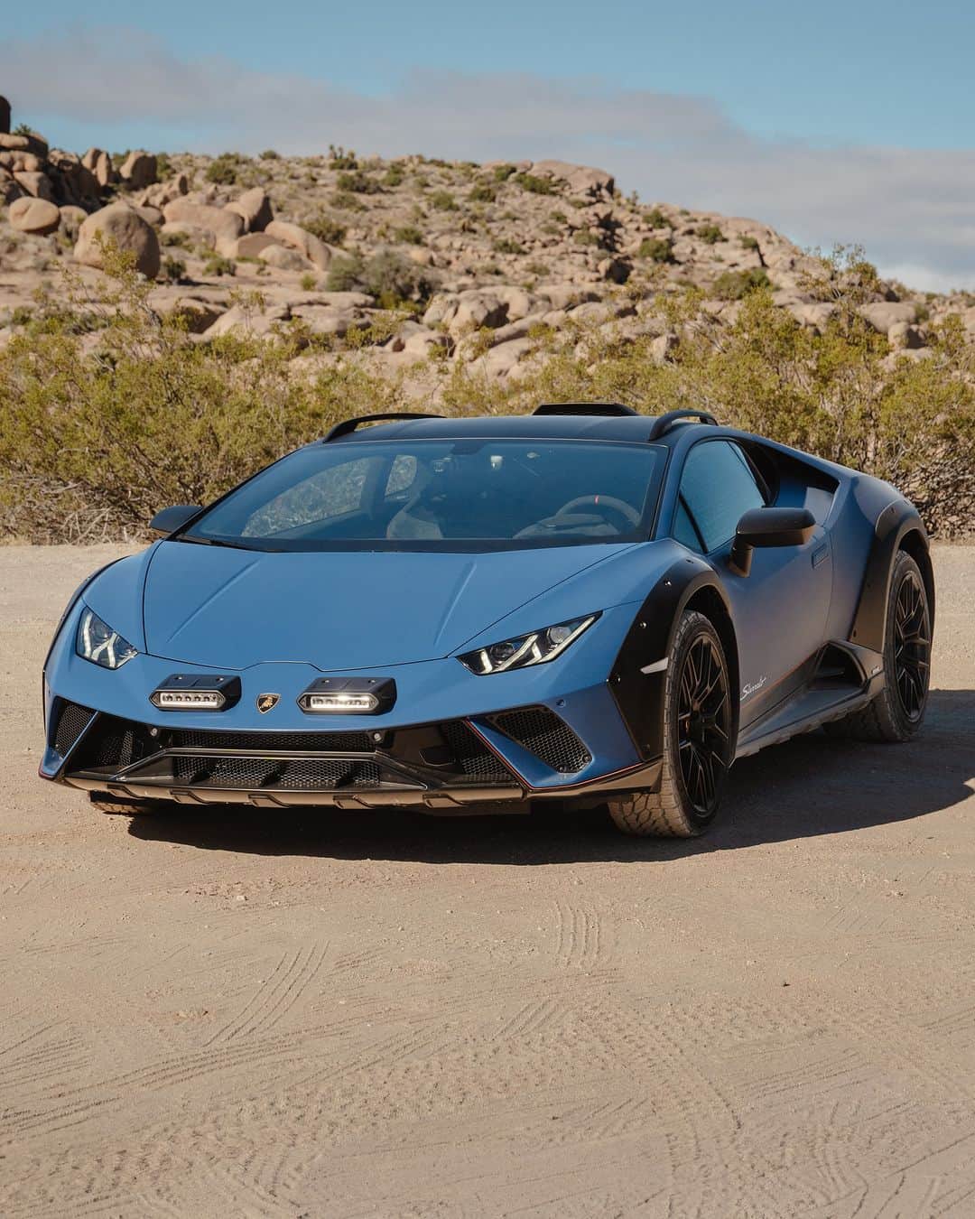 ランボルギーニのインスタグラム：「Raising dust means you’re having fun. And Huracán Sterrato helps you with that for sure.  #Lamborghini #HuracanSterrato #BeyondTheConcrete  __ Huracán Sterrato: fuel consumption combined: 14,9 l/100km (WLTP); CO2-emissions combined: 337 g/km (WLTP)」