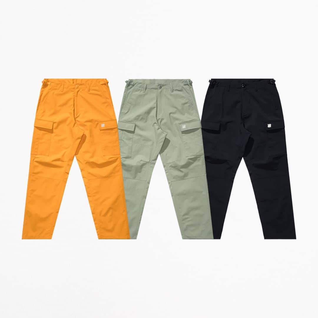 UNDFTDのインスタグラム：「A detailed look into UNDEFEATED FALL 23 - Drop 6  The UNDEFEATED Tech Cargo Pant, a 100% nylon water repellent piece featuring a zip fly, adjustable waistband tabs and a 3M reflective screen printed ‘5-strike’ icon on the left cargo pocket. Available in Orange, Light Sage and Black.  Available Friday, 10/20 exclusively at all UNDEFEATED Chapter Stores and Undefeated.com」