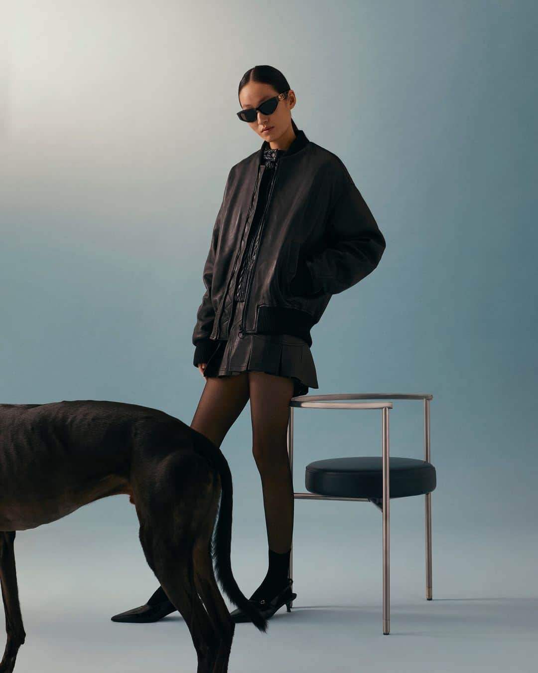 トラサルディのインスタグラム：「The House's leather roots are highlighted throughout the #TrussardiFW23 collection in statement leather pieces, such as this oversized leather bomber jacket for men and women. The look is photographed with Ballyhone Blake Tom, a greyhound from Milan.」
