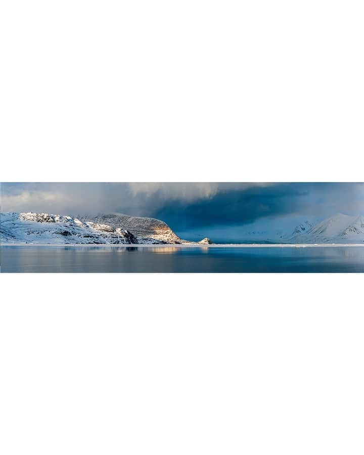 National Geographic Travelさんのインスタグラム写真 - (National Geographic TravelInstagram)「Photo by @martinedstrom | Swipe to see the full panorama from Svalbard, Norway. Traveling through the Arctic beneath the midnight sun is a meditative experience. The sun never sets, so you sleep less and have golden light throughout the entire day. But the weather changes quickly, as seen here, when a thick, deep-blue storm rolled in from the west.   Follow @martinedstrom for more travel images from the Nordics.」10月22日 5時29分 - natgeotravel
