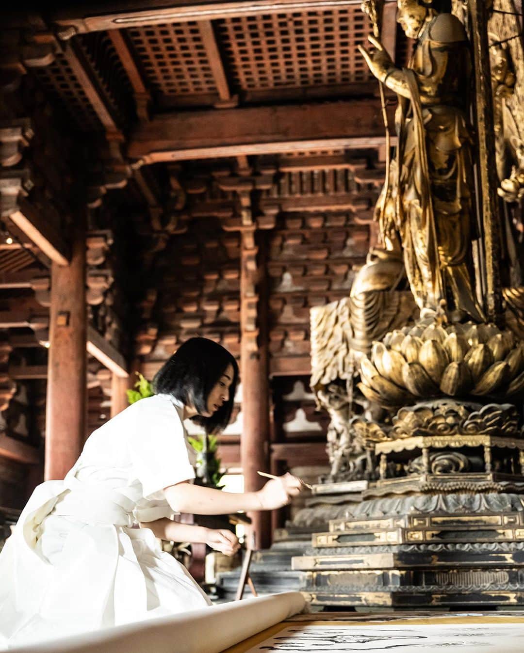 小松美羽のインスタグラム：「New Project: "Sense of Sacredness" - Protecting Cultural Properties Through the Power of Art  Miwa Komatsu's creative philosophy, "The Great Harmonization," posits that all living beings are equal in spirit and that every entity can coexist while maintaining its unique essence. At its core lies the primal sense of awe inherent in every human, a universal sacred sensation transcending specific religions, which we redefine here as the "Sense of Sacredness."   Temples and shrines serve as the physical embodiment of this "Sense of Sacredness," and it's for this reason that we believe in the necessity of their protection. While Miwa Komatsu performs live painting as part of her artistic expression, it's not mere performance. It's a solemn ceremony leading to a realization of the "Sense of Sacredness."   Globally, historical cultural assets face extinction due to factors like wars, poverty, and economic stagnation. We view these assets as humanity's historical inheritance, anchoring our souls, and aim to protect them.  The goal is to shift values from the traditional concept of "receiving goods or services in exchange for payment" to "voluntarily contributing one's assets for public good, subsequently receiving admiration and honor from the community." This transformation is to be implemented using technologies like blockchain, encouraging broader participation.  Specifically, donors will receive physical and digital ownership of artworks, certificates of appreciation from the cultural entities, among other forms of acknowledgment. A part of the proceeds from secondary market sales of digital artworks will continue to contribute to the cultural assets, fostering a sustainable cycle for their protection.  For this initiative, we received empathy from To-ji Temple, initiating our pilot project. Plans are in motion to expand not just in Japan but globally, with Mont Saint-Michel being considered for our next venture.」