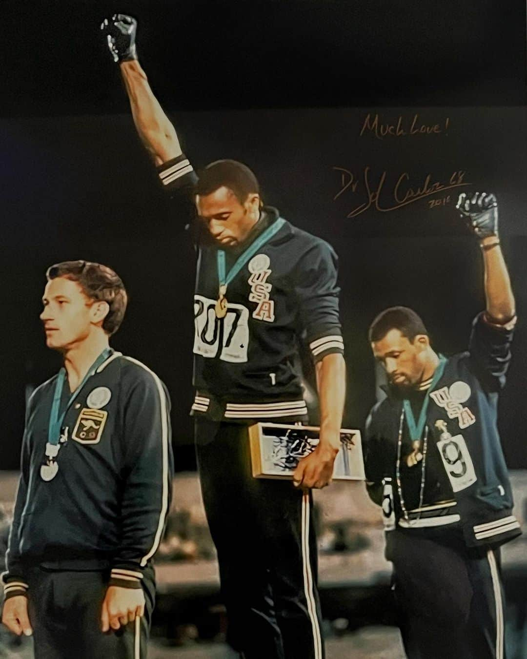 Robert Clarkのインスタグラム：「I walk past this photo every morning & in my opinion is one of the most important sports pictures ever shot.  My wife @lailingjew came home from a fundraiser one evening carrying the photo and asked me if I knew anything about it and if I liked it. She said I thought that you might like it & it is signed by Dr. Juan Carlos. Hard to imagine that 55 years ago today Tommie Smith & Juan Carlos won gold & bronze medals in the 200 meter dash @ the #mexicocityolympics in 1968. But the event that these two American sprinters are remembered for came after the race and after the presentation of the medals & during the National Anthem, these two very brave civil rights activists raised their fist one right hand & one left, sharing one pair of gloves they raised their fists in a silent protest against racial inequality in the United States. The stance that Smith & Carlos took for their convictions got them suspended and sent home by the US Olympic Committee, the photo was seen around the world and has become an iconic moment in sport’s history for awareness of the racial injustice in the United States. The photo has deep mean & an incredible story hidden in the details. The story of the Australian silver medalist Peter Norman adds to the importance of the moment, he wore a badge on the podium in support of the Olympic Project for Human Rights (OPHR). After the final, Carlos and Smith had told Norman what they were planning to do during the ceremony. They asked Norman if he believed in human rights. He said he did. They asked him if he believed in God. Norman, who came from a Salvation Army background, said he believed strongly in God. We knew that what we were going to do was far greater than any athletic feat. He said, 'I'll stand with you'. Carlos said he expected to see fear in Norman's eyes. He didn't; 'I saw love'. After the 1968 Olympics, Norman's career suffered greatly, when he returned home to Australia a pariah, suffering unofficial sanction and ridicule as the Black Power salute's forgotten man. Check out a video @voxdotcom for the whole story. #tom mieSmith #johncarlos」