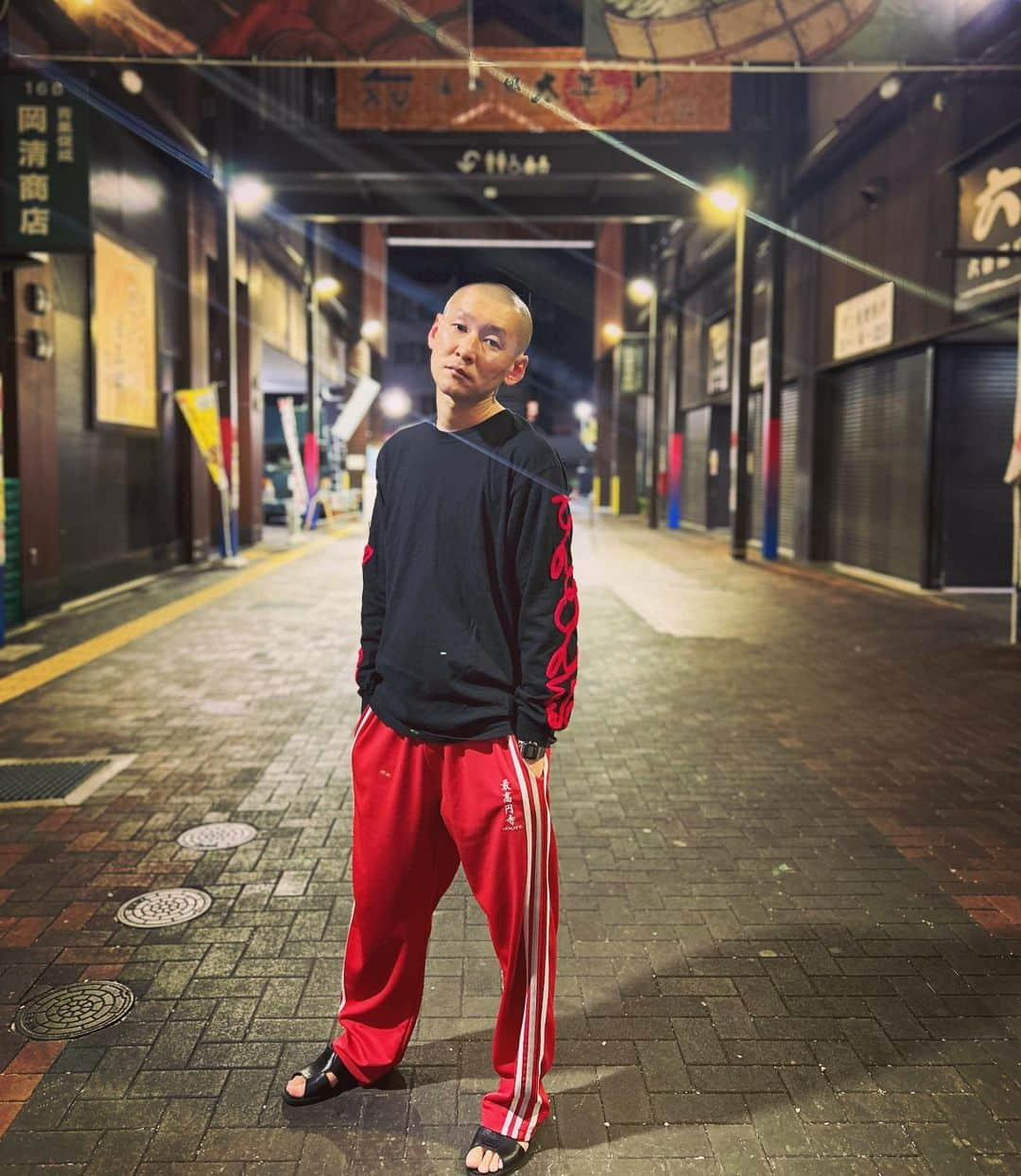 市川刺身さんのインスタグラム写真 - (市川刺身Instagram)「今日の服装。 大阪にてなんばグランド花月に出させていただく日。  男性ブランコさんの単独てんどん記のグッズ『途中でやめる。』さんのロンT。 最高円寺の赤ジャージ。 黒の便所サンダル。  大阪でなんばグランド花月3ステ出させて頂いて明日も大阪で仕事なので泊まり。 ザ・ぼんちの里見まさと師匠に『ええヤンキーになる。逸材や。』と言ってもらいました。 スーパー銭湯まで歩いて行って風呂上がりに撮りました。 気合い入れていこう。 スーパー銭湯ありがとう。  #今日着た服 #ファッション #古着 #大阪 #ヤンキー」10月24日 0時54分 - soitsudoitsu