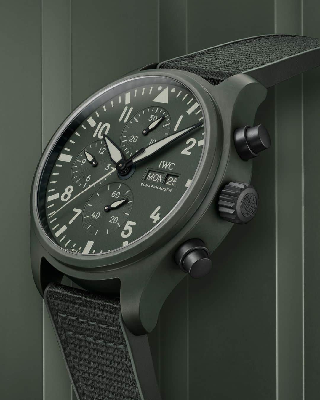 IWCのインスタグラム：「Earthed dark green.  The monochromatic design of the Pilot's Watch Chronograph Top Gun Woodland, developed in collaboration with @pantone is completed by crown, pushers and case back made in matte black Ceratanium®. Ticking away inside the case of this timepiece is the IWC-manufactured 69380 caliber, a soft-iron inner case shields the movement from the effects of magnetic fields.  #IWCpilot | #IWCtopgun | #IWCwoodland | #TheReference  🔗Link in Bio  ℹ Woodland dial Ceramic case 44.5mm IWC-manufactured 69380 Calibre Ref. IW389106」