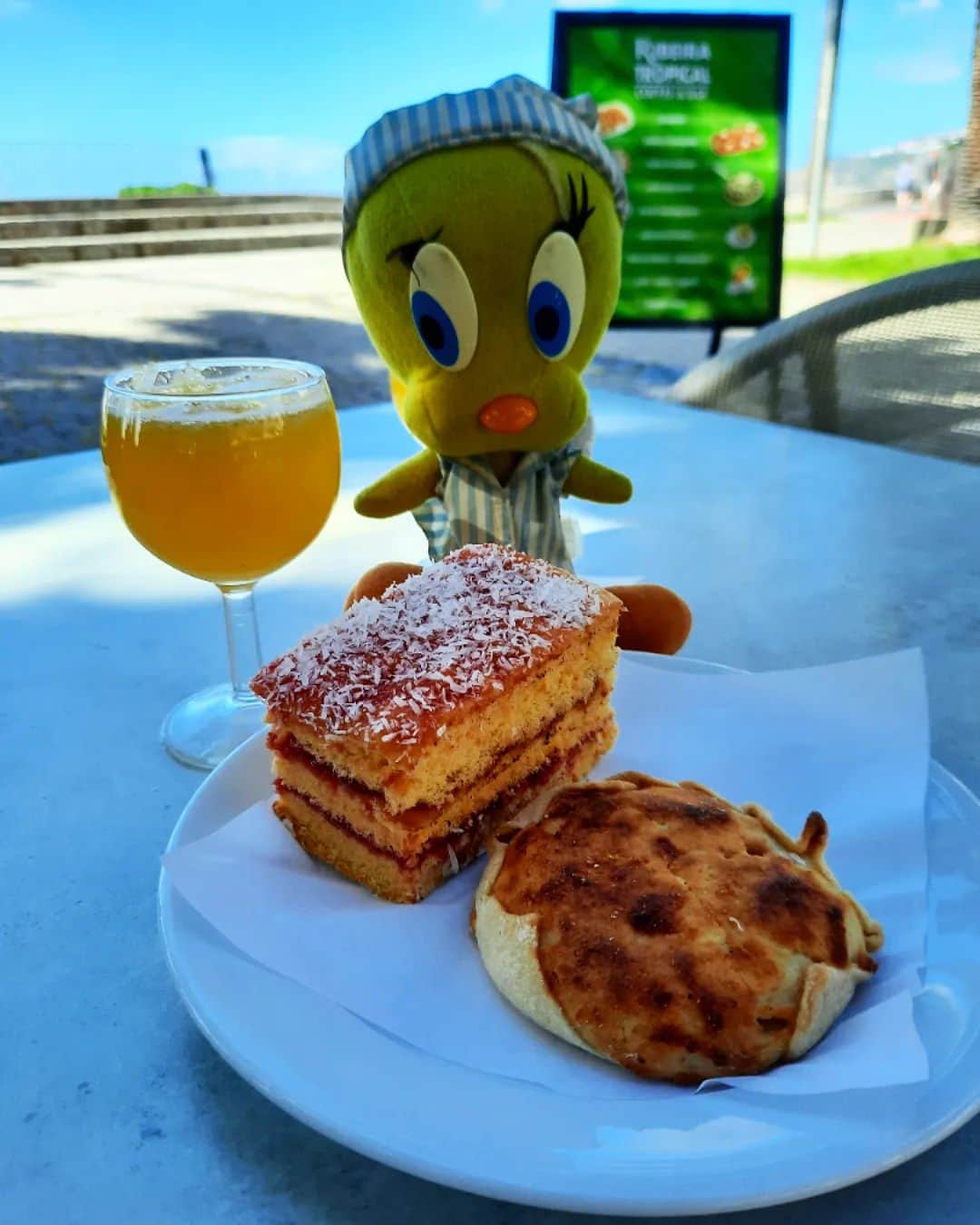 Little Yellow Birdのインスタグラム：「Another true delight of Madeira: poncha. Its a strong punchy drink, made of lemon- and orange juice, honey and rum! I'm having some cake too, because tomorrow is already my last day on Madeira,  and you only live once, right! #littleyellowbird #tweety #tweetykweelapis #adventures #yellow #bird #holidays #madeira #island #drinks #cake #poncha #cake #robeirabrava #stuffedanimalsofinstagram #plushiesofinstagram」