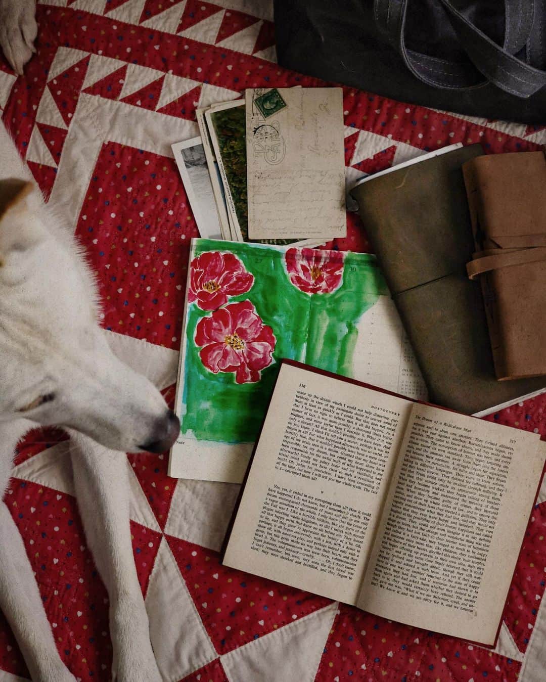 Catharine Mi-Sookのインスタグラム：「A study in vibrant gouache on unused planner pages, an uncanny short story by Dostoevsky, a couple journals of late, old postcards & photos, a bag to stow, a quilt as old as I, and a curious pup who is always by my side.」