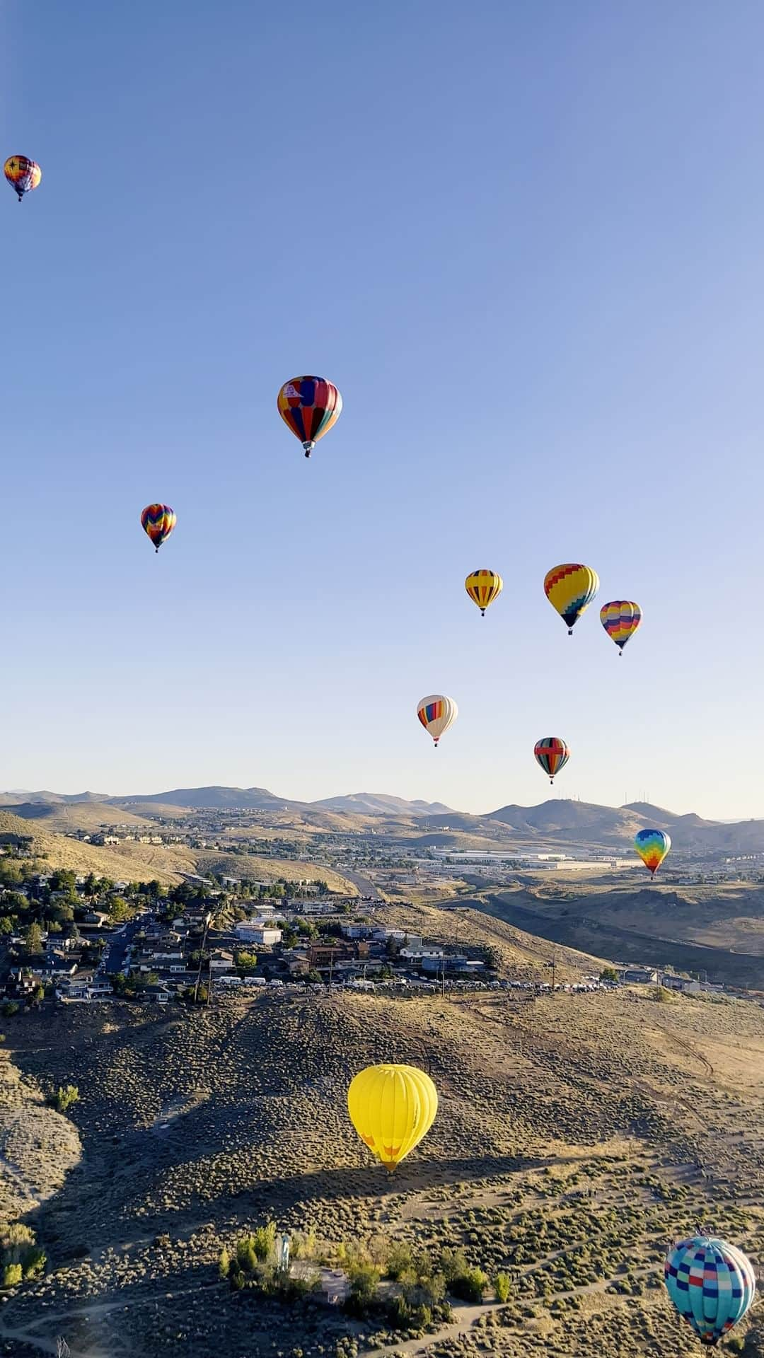 National Geographic Travelのインスタグラム：「Video by @joshuacogan | In September, I had the chance to attend the Great Reno Balloon Race outside Reno, Nevada, where around a hundred vibrant balloons filled the skies above the desert. I’ve experienced many modes of transportation, but there is something uniquely special about being in a hot-air balloon. The intermittent silence and the sensation of being gently carried instantly reminded me of childhood dreams of floating. Predawn flights—ascending as the sun broke the horizon and feeling the thermals and wind direction rapidly change—placed me in direct contact with the elements in a way few other experiences have. | In the Silver State find the unexpected, the uncommon, and all the things in between. Go on, #GetALittleOutThere and experience what makes Nevada so special. @travelnevada」