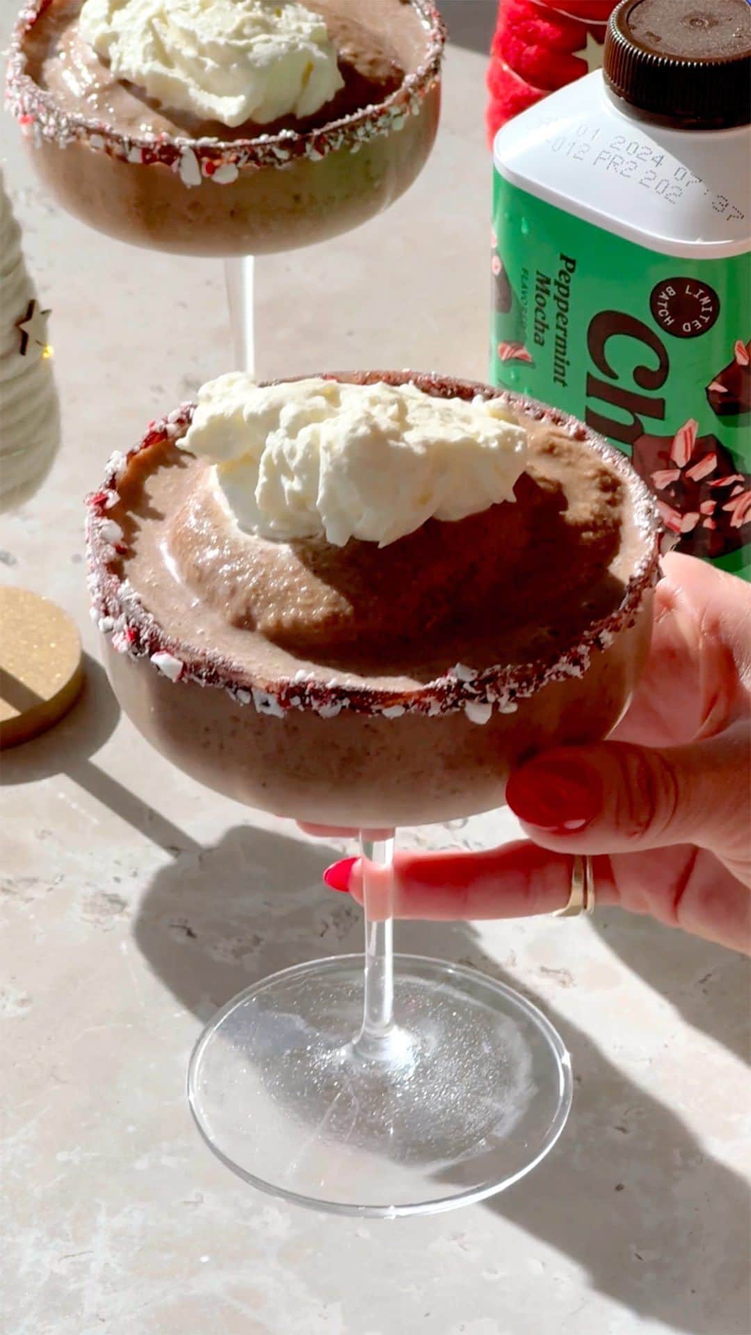 Chobaniのインスタグラム：「Indulge in the magic of the holidays with every sip of this Frozen Peppermint Mocha Mocktini. Crafted with @Chobani’s Coffee Creamer Peppermint Mocha, it’s a frosty, festive treat that’ll make your season merry.  ❄️ Ingredients ❄️   • Chocolate, melted (for rimming the glasses) • Peppermint candy, crushed (for rimming the glasses) • 2 cups frozen coffee cubes  • 1 cup ice  • 2 tbsp sweetened cocoa powder  • 1/3 cup Chobani® Coffee Creamer Peppermint Mocha • 3/4 cup Chobani® Oatmilk (or any nut milk)  • Pinch sea salt  • Whipped cream, for garnish   🍫 Directions 🍫  1. Rim two martini glasses with melted chocolate and crushed peppermint candies. Put glasses in the freezer while you prepare your drink.  2. In a blender, combine frozen coffee, ice, cocoa powder, peppermint mocha creamer, milk, and salt. Blend until smooth.  3. Pour mixture into your prepared glasses and top with a dollop of whipped cream.   #peppermintmocha #mocktini #holidaydrinks #frozendrinks」