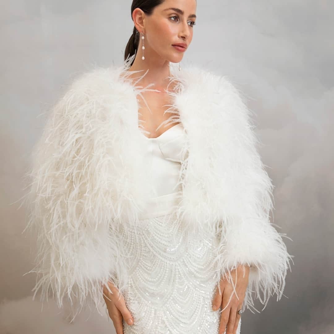 キャサリンディーンのインスタグラム：「Introducing our luxurious Arlo Feather Jacket! 😍⁣  Brides looking for the the perfect bridal cover-up, look no further than the luxurious Arlo Jacket. This boxy fit, waist length statement jacket is adorned with snowy white ostrich feathers and fully lined.  Add this beautiful jacket to your bridal look.  #catherinedeane #cdbrides #cdlove #arlojacket」
