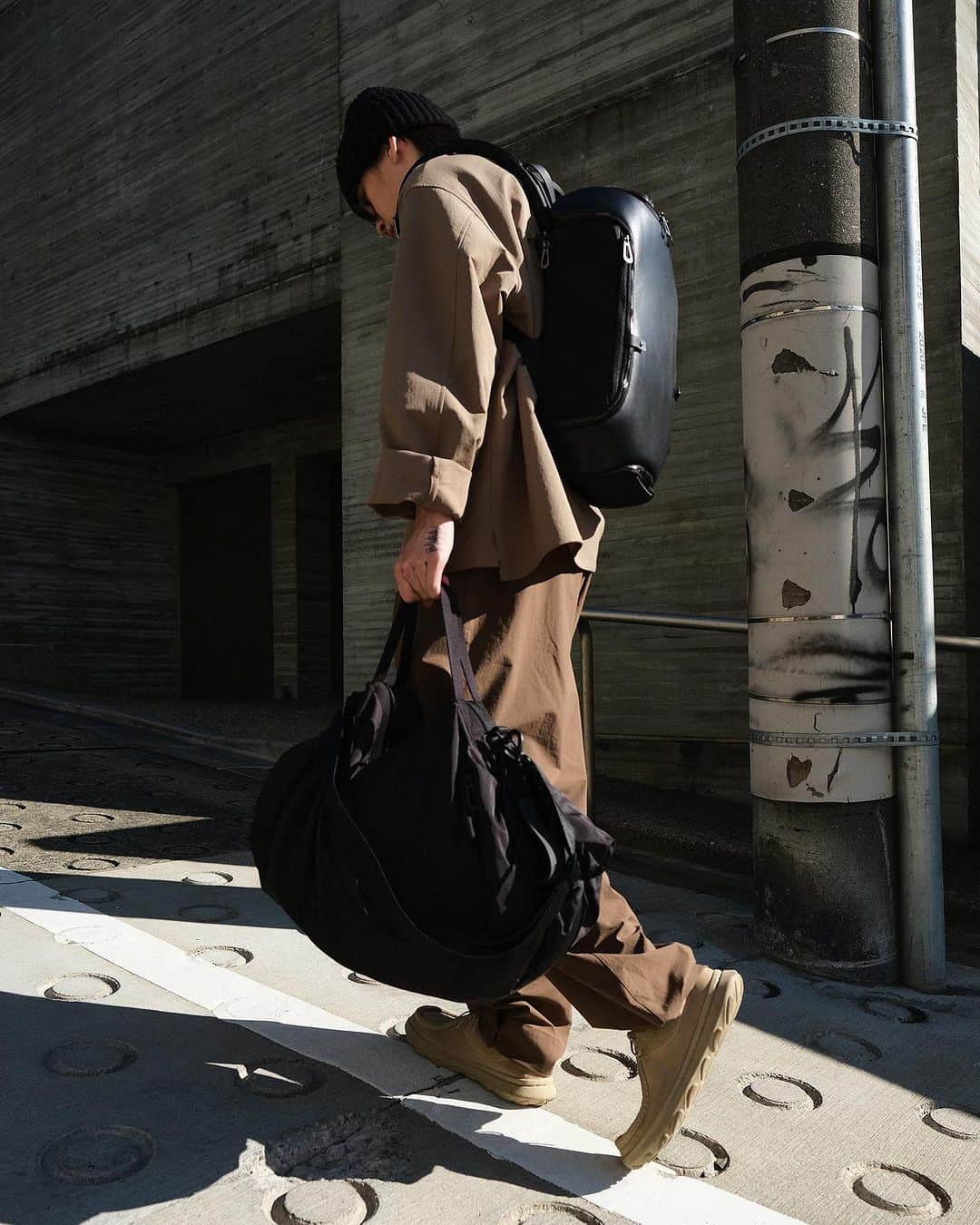 コートエシエルのインスタグラム：「côte&ciel, at home in Tokyo.   Featuring a harmonious blend of natural and manmade elements, from brushed concrete to moulded stone pillars, Daikanyama, the primary location for the shoot,  brings a sense of equilibrium and clarity to a city renowned for its dynamism.  Image Credits:  Styling & Photography: @graemegaughan Assistant: @cauliflower.zip Model: @n00bcyb0t」