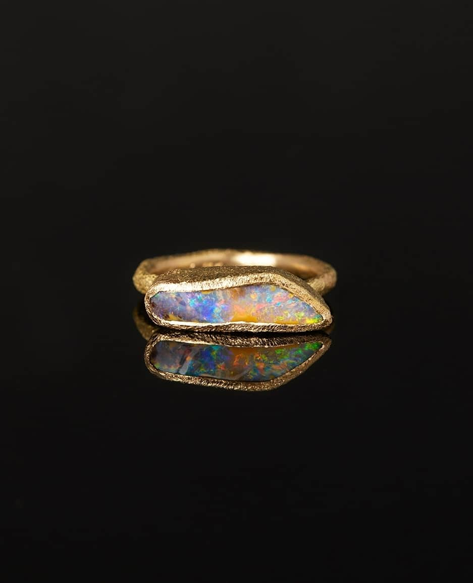 サトミ カワキタのインスタグラム：「Like a fire within, this kaleidoscopic opal One-of-a-Kind ring is a micro-cosmos, beckoning to be explored. Just in time for October, this birthstone ring features a 3.17 carat Boulder Opal set in a richly textured 18K Yellow Gold.」