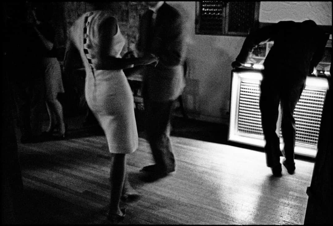 Magnum Photosのインスタグラム：「Underground nightclub in Cable Street (1964) by @ianberrymagnum 🕺⁠ ⁠ After a decade of traveling, Ian Berry conceived of The English as a project that would enable him to both document and rediscover the country in which he was born and grew up.⁠ ⁠ This photograph from the series, which depicts an underground nightclub on Cable Street, East London, as patrons dance the night away by a jukebox, was used on the cover of Bob Dylan's album Rough and Rowdy Ways. ⁠ ⁠ Discover our selection of signed fine prints by Ian Berry at the link in the @magnumphotos bio.⁠ ⁠ PHOTO: Underground nightclub in Cable Street. East London, England. 1964. ⁠ ⁠ © @ianberrymagnum / Magnum Photos」