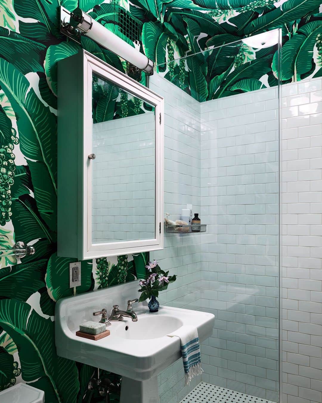 ELLE DECORのインスタグラム：「“An oasis within an oasis.” That’s how actor Michael C. Hall (@mchdaily)—aka the star behind the TV show Dexter—describes the guest bath in the New York apartment he shares with his wife, Morgan. The couple enlisted interior designer Sara Bengur (@sarabengur) to imbue the home with elegance and color. Here, a Dorothy Draper banana leaf wallcovering climbs from the walls onto the ceiling. “We could never have approached such a result without her expertise, guidance, and taste,” says Hall.   Click the link in bio for the full tour, as shown exclusively on elledecor.com. Written by @ingridabram. Photographed by @richardpowersphoto. Styled by @anitasarsidi.」
