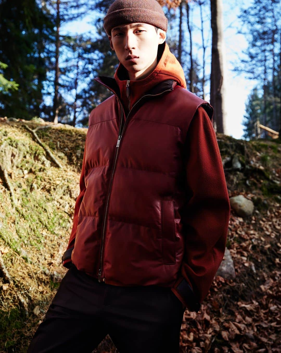 ベルルッティのインスタグラム：「- THE SILHOUETTE: PEAK POINT BY #BERLUTI -   Technical features meet a lush spirit as Berluti’s iconic B-Way jacket gets a new cashmere version. With an Orange Rust tone winking to classic outdoors-ready styles, the hooded jacket features a lightly quilted lining for extra warmth. Paired with a sleeveless leather down jacket, it creates an everyday Winter look to wear on all occasions.   Now available online and in-store.  Styling by @virginiebenarroch  Photography by @anthonyseklaoui   #BERLUTIWINTER2023」