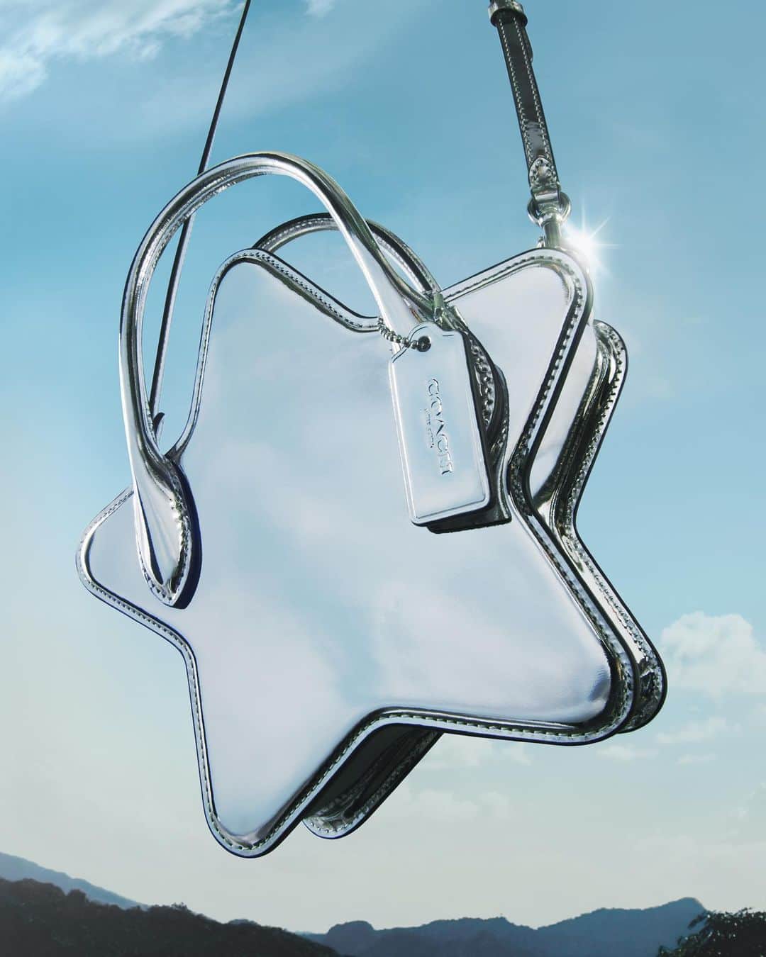 のインスタグラム：「QUICK, make a wish in the comments. 🌠 The Star Bag in silver metallic drops tomorrow, 11/1.  #WearYourShine. Our Fall 2023 story is a call to resist your inner critic and show your most confident self.  #CourageToBeReal #CoachNY」