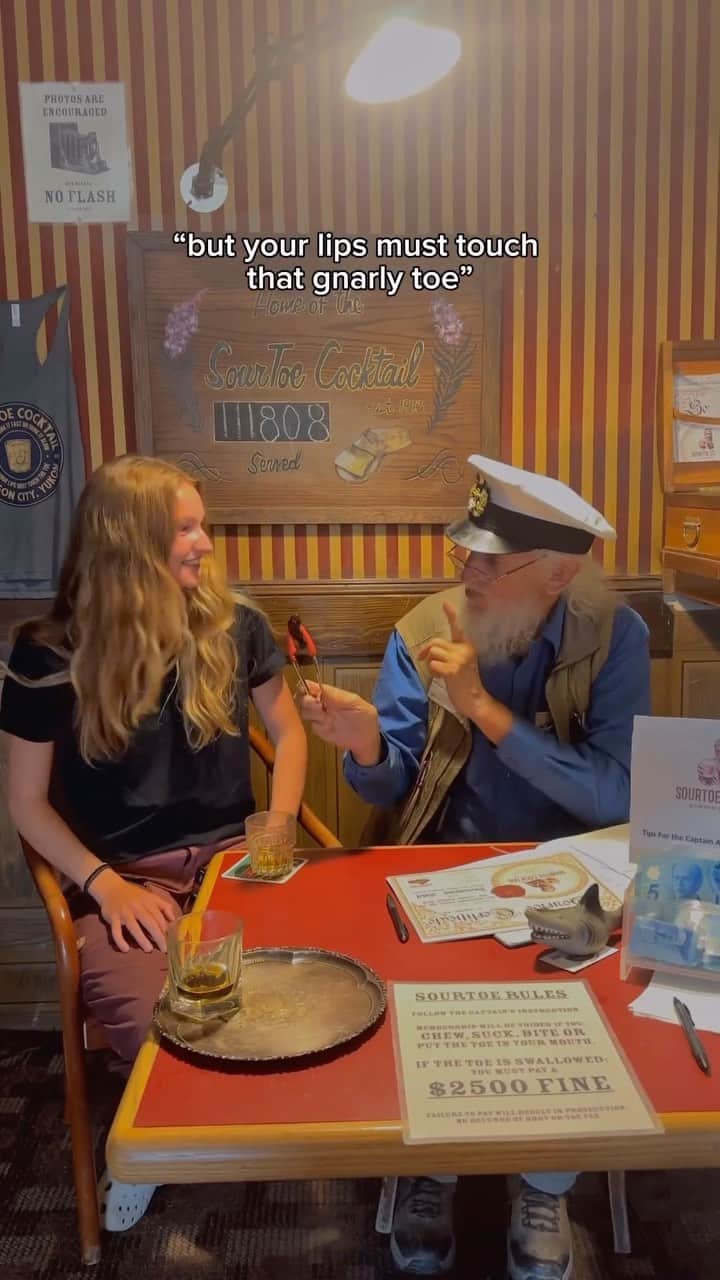 Explore Canadaのインスタグラム：「Would you try this toe-tally unique drink? 🦶🥃  The Sourtoe Cocktail, which can be found at the Sourdough Saloon in Dawson City, is a rite of passage for those visiting The Yukon.  Established in 1973, those who complete the challenge are admitted into the Sourtoe Cocktail Club. There’s just one rule: “You can drink it fast. You can drink it slow. But your lips must touch that gnarly toe.”  Tag someone you would want to try this with 👇  🎥: @danimarielister  📍: Dawson City, Yukon @travelyukon  #ExploreCanada #ExploreYukon  Image/Video description:  Various clips showing a woman walking into a red building, a tray with a glass of whisky and mummified toe on it, a man holding the toe between tongs, a woman drinking the cocktail and getting handed a certificate for completion then walking out of the building.」