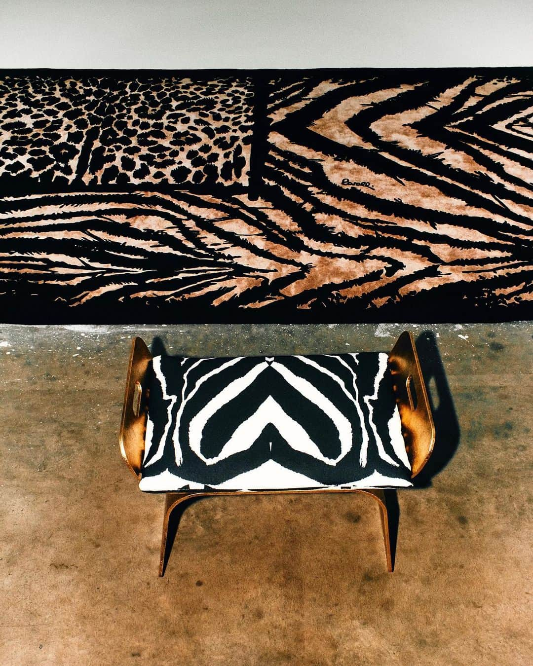 ロベルトカバリのインスタグラム：「A flag, with the stars replaced by jaguar spots and the stripes by a zebra pattern in sepia tones, accompanies and enhances the unique style of Iranja, a bench with compact proportions and a captivating geometric design: discover the rock 'n' roll spirit of #RobertoCavalliHome at RobertoCavalli.com」