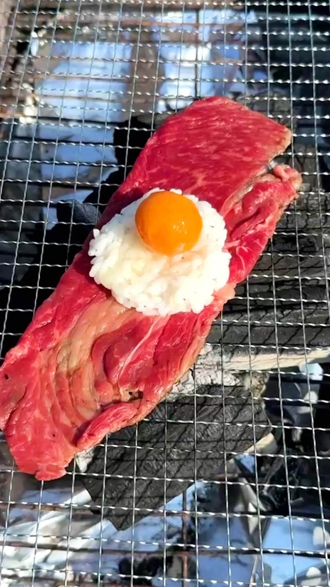 Tasty Japanのインスタグラム：「@tastyjapan 👈他のレシピもチェック！ 【1個入れるだけで極上おにぎり！？】無限におかわりが止まらない！！  レシピが知りたい方はプロフィールのリンクをクリックしてね♪  ===  Nikumaki Onigiri (meat-wrapped rice balls) Servings: 1  INGREDIENTS 1 egg (frozen) 1 beef thin slice Steamed rice, as needed Japanese BBQ sauce, as needed  PREPARATION 1. With rinsing water, peel the frozen egg. Thaw the egg and separate the egg yolk. 2. On the beef slice, put the rice and the egg yolk (1). Add some BBQ sauce. Shape the rice ball. 3. Cook (2) until the beef is done. 4. Enjoy!  #tastyjapan #BBQ #肉巻きおにぎり #おにぎり」