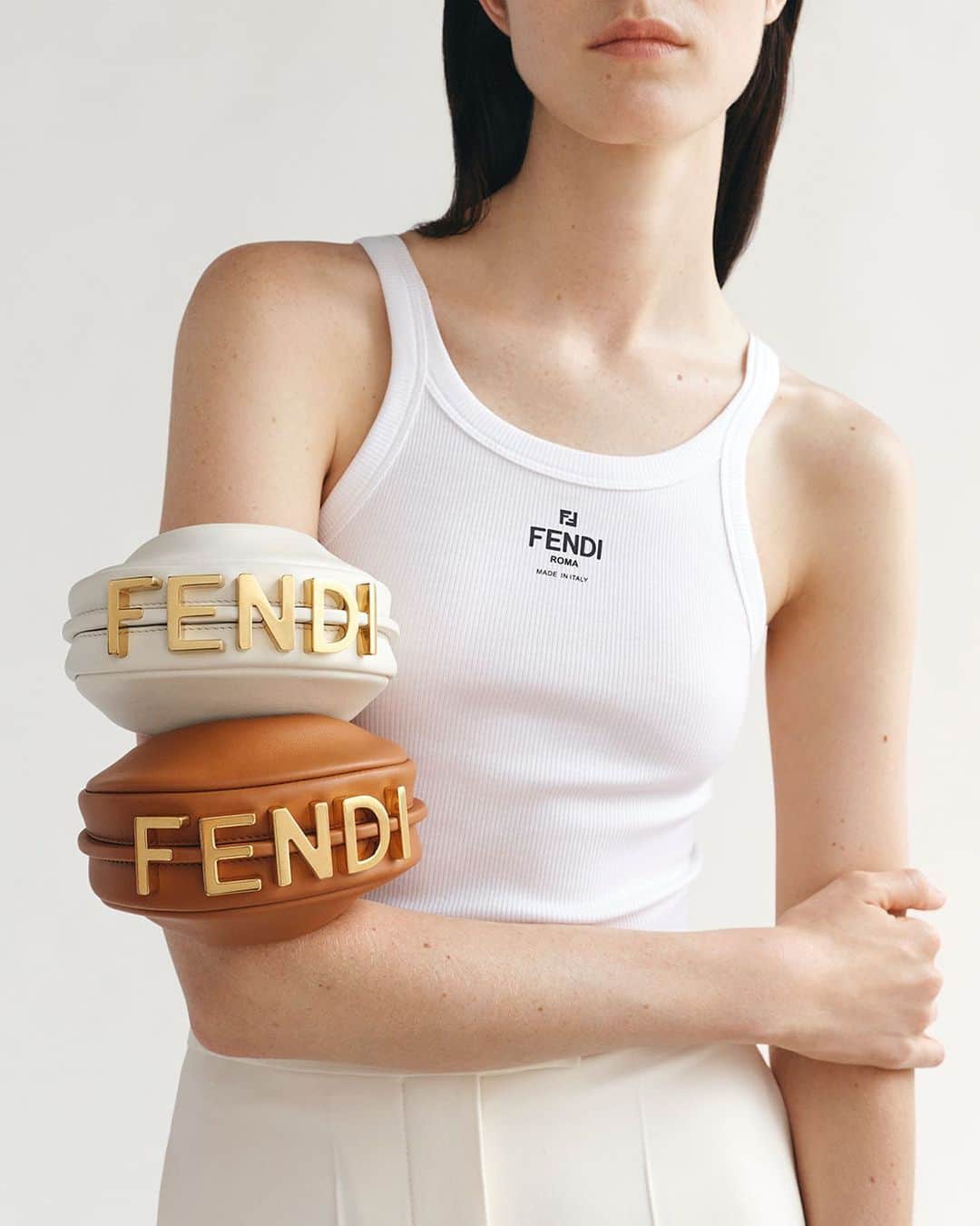 Fendiのインスタグラム：「Emboldened with vintage gold lettering, the #Fendigraphy Nano bag is available in a harmonious palette of neutrals.  Shop the versatile style in a full range of sizes and colourways in boutiques and at Fendi.com.  Artistic Director of Couture and Womenswear: @mrkimjones  Artistic Director of Accessories and Menswear: @silviaventurinifendi  Artistic Director of Jewellery: @delfinadelettrez  Styling: @nilonilo_ Grooming: #ShingoShibata  Casting: @shelleydurkancasting  Photography: @ellenfedors_  Set: @mattjacksonmattjackson」