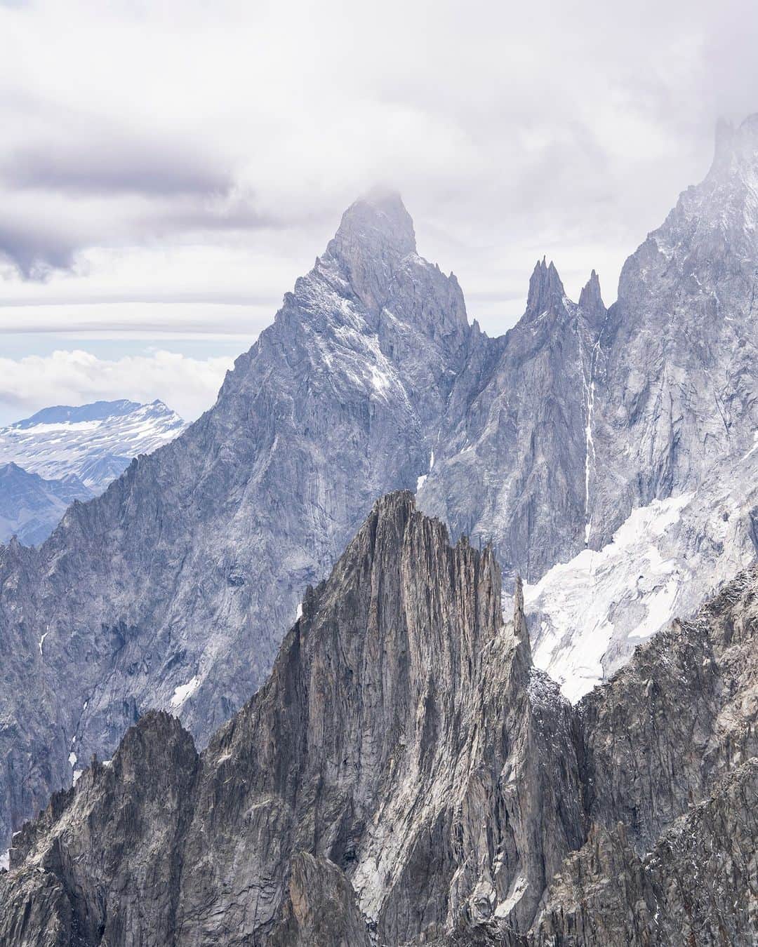 National Geographic Travelのインスタグラム：「Photos by @andrea_frazzetta | After studying Monte Bianco (Mont Blanc)—the highest mountain in Italy—my son decided he wanted to see it. We went for his birthday. The closest access point to the summit (4,810 meters, or 15,800 ft) is at an altitude of 3,466 meters (11,400 ft), a distance we covered in a few minutes thanks to a trip on a cable car. I’m not typically a fan of shortcuts, but this mode allows many people who might not ordinarily been able to do so to have the inspirational experience of finding themselves facing an unparalleled landscape. As a father, I hope my son will never forget the biting winds on his face, the reflection of light on the snow, the dip in his heart at the sight of the clouds swirling around the peak.  Follow @andrea_frazzetta for more images and stories.」