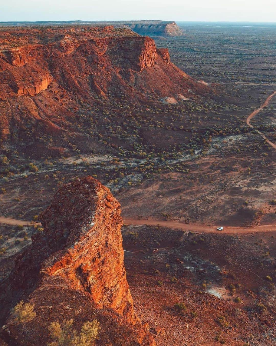 Australiaさんのインスタグラム写真 - (AustraliaInstagram)「Ah, Kennedy Range National Park, you're perfection 🧡 Today, we're going off-road with @sailor.jay and @redsands_campers as they transport us to Mundatharrda (#KennedyRangeNationalPark) in @westernaustralia's Gascoyne region. While you're here, make sure to visit #HoneycombGorge and marvel at the fascinating cavities that have been eroded into the cliff face 🐝 Explore the dramatic landscape of Kennedy Range on a day tour with #NaturetimeTours or extend your stay and set up camp under the brilliant star-filled sky!  #SeeAustralia #ComeAndSayGday #WATheDreamState   ID: a vast outback landscape. Large red cliffs rise up in the foreground and to the left of the frame. In the valley, a red dirt road winds its way through the rugged landscape.」11月2日 4時00分 - australia