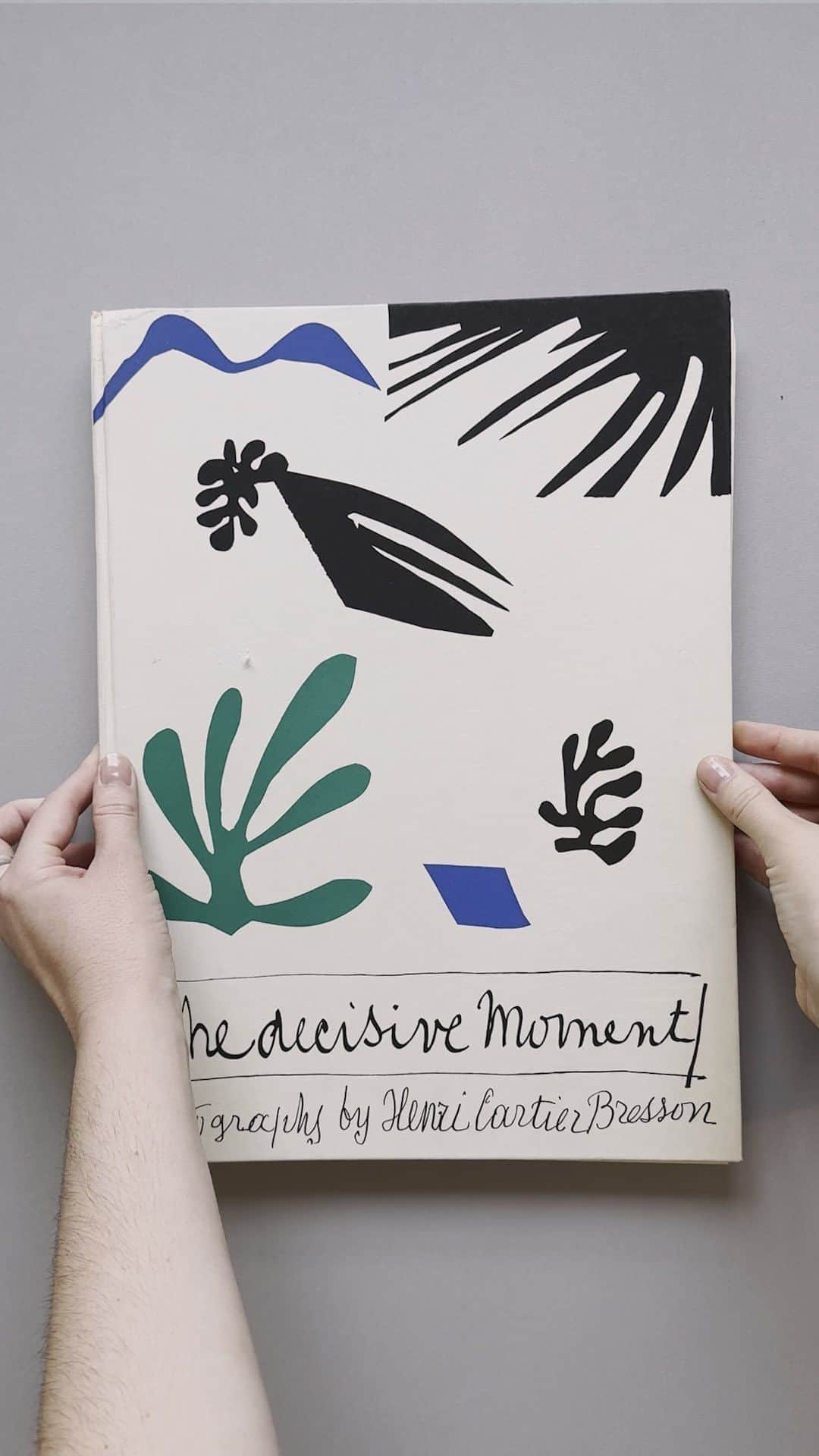 Magnum Photosのインスタグラム：「#MagnumBookClub: The Decisive Moment by Henri Cartier-Bresson (@fondationhcb) 📖  Browsing the Magnum Photos library in London, Retail & Publications Manager @chilli.power picks up a copy of Henri Cartier-Bresson’s The Decisive Moment, one of the most influential books in photography history. Published in 1952 by Simon & Schuster in collaboration with Editions Verve, the collage cover was designed by Henri Matisse using his signature cut-out technique.   #HenriCartierBresson #MagnumPhotos #TheDecisiveMoment #HenriMatisse」