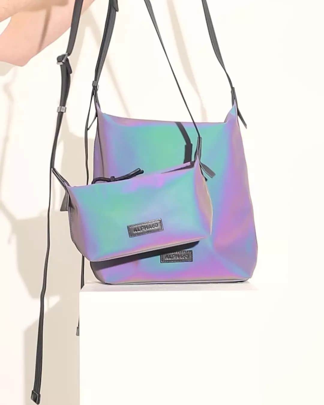 アルファ60のインスタグラム：「Have you met RHEA + DARCY?   Our newest bags made using an epic holographic nylon fabric. Each bag comes fully lined and has adjustable straps that allow for multiple styling options 🧬💠💜☑️」