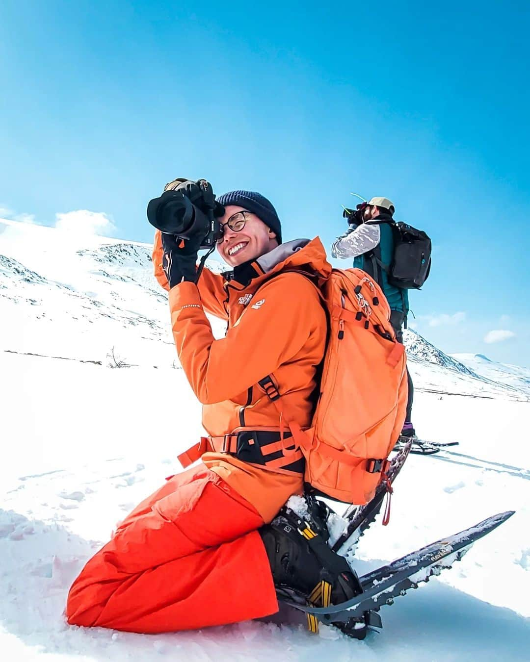 Explore Canadaさんのインスタグラム写真 - (Explore CanadaInstagram)「Meet the next five creators in our Creators Network!  Head to our previous posts to learn more about our new Creators Network and the other creators.  📷 Photo 1-2: Tom @tomcochrane, Newfoundland & Labrador 📷 Photo 3-4: Kara @karaokeefe, Newfoundland & Labrador 📷 Photo 5-6: Ash @lifeofashmac, Nova Scotia 📷 Photo 7-8: Adam @acorn_art_photography, Nova Scotia 📷 Photo 9-10: Desmond @desmondstuartsimon, New Brunswick  #ExploreCanada #ExploreCanadaCreator  Image description:  Photo 1) Person in orange ski clothes looks through their camera and points it into the distance. Behind him, another person is pointing their camera in the other direction. Both are standing on a snowy mountain top with blue sky above. Photo 2) Aerial image of houses scattered along a strip of land covered in snow, surrounded by water. In the distance orange and purple clouds float in the sky. Photo 3) Side profile of a in a plaid jacket staring off camera. Behind her are multiple houses lined up on a cliff. Photo 4) A window is open with trinkets are scattered around the wall. Through the window you can see a couple houses on the side of a cliff, rocks and water. Photo 5) Person wearing a yellow jacket smiling at the camera. Body of water with rocks and a pink and blue sky are in the background. Photo 6) Aerial view of a beach. To one side there are scattered green trees in the sand. The other side there’s blue green water. Photo 7) Person in blue jacket smiles, green trees are blurred in the background. Photo 8) Two hockey players are passing a puck across a frozen body of water. Grey rock formations are stacked on either side of the water. A lighthouse is in the distance. Photo 9) Person smiling, sitting on steps. White window behind him. Photo 10) Aerial shot of an evening sky as it washes over a bridge and body of water.」11月4日 1時31分 - explorecanada