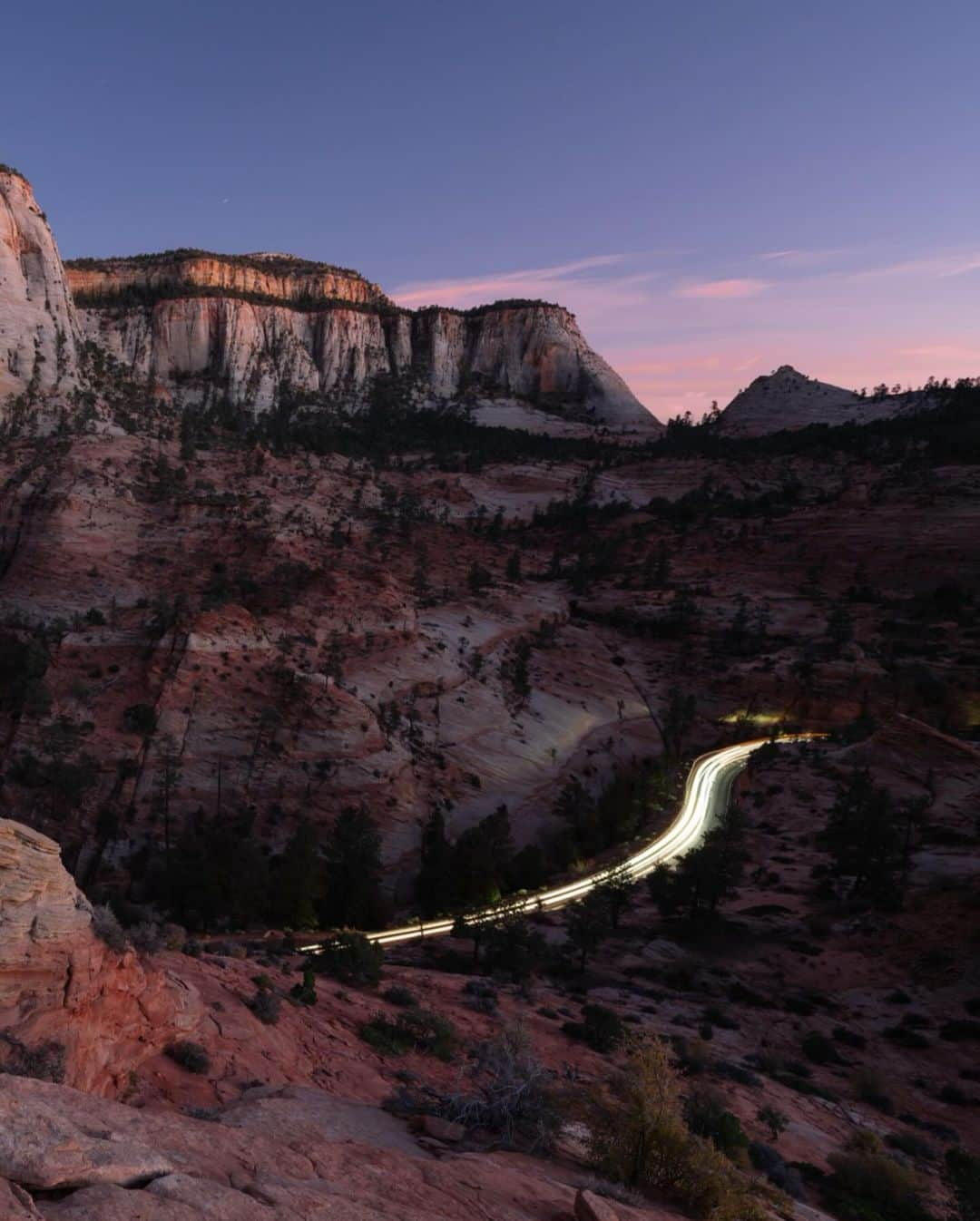 Keith Ladzinskiさんのインスタグラム写真 - (Keith LadzinskiInstagram)「Lines of traffic illuminating a windy road in Zion National Park, the 3rd most visited in the US parks system. This photo was about as unplanned as it gets, a scene I spotted as I was hiking back to the car after the sun had set. Down canyon I saw a procession of slow moving cars meandering up the road. With little time to spare I raced to a higher vantage, made a rushed composition, exposure calculation of 60 seconds and fired of one frame before the cars faded into the distance, leaving behind this parting frame here. / For @natgeo」11月5日 0時32分 - ladzinski