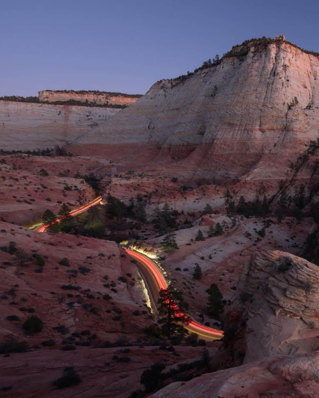 Keith Ladzinskiさんのインスタグラム写真 - (Keith LadzinskiInstagram)「Lines of traffic illuminating a windy road in Zion National Park, the 3rd most visited in the US parks system. This photo was about as unplanned as it gets, a scene I spotted as I was hiking back to the car after the sun had set. Down canyon I saw a procession of slow moving cars meandering up the road. With little time to spare I raced to a higher vantage, made a rushed composition, exposure calculation of 60 seconds and fired of one frame before the cars faded into the distance, leaving behind this parting frame here. / For @natgeo」11月5日 0時32分 - ladzinski