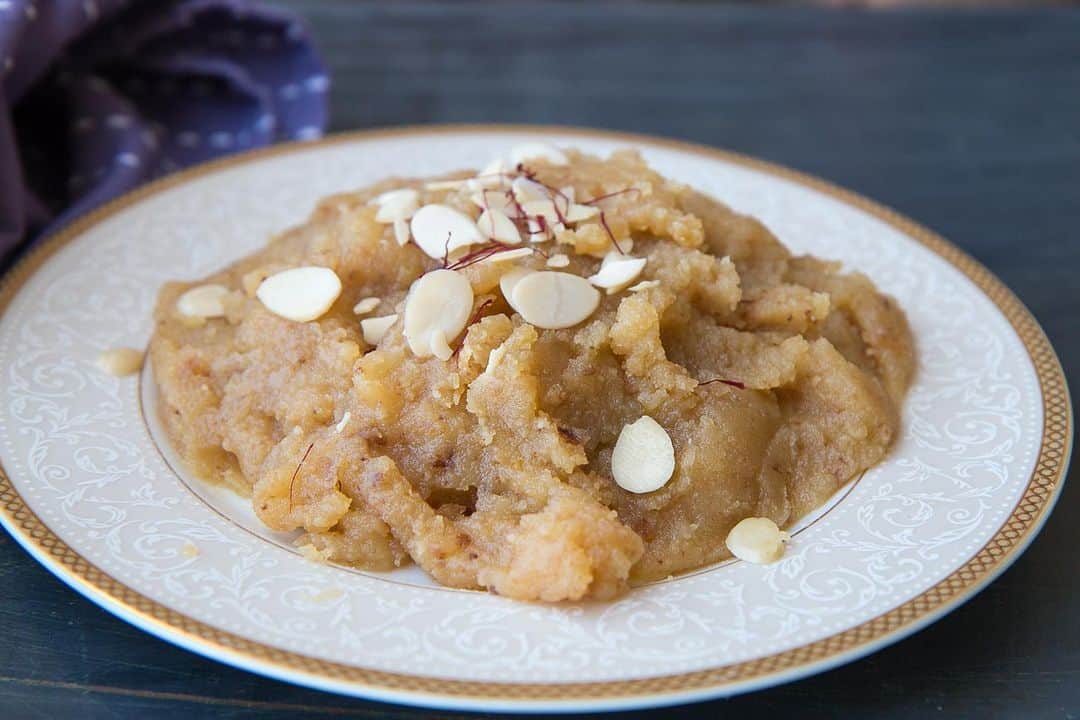 Archana's Kitchenのインスタグラム：「#DiwaliRecipes   Indulge in the delectable Badam Halwa; the perfect dessert to enjoy this Diwali :)  1 cup Whole Almonds (Badam) 1/2 cup Ghee 3/4 cup Milk 1 tablespoon Whole Wheat Flour 3/4 cup Sugar 3 Saffron strands 1 tablespoons Slivered Almonds   👉To begin making the Badam Halwa Recipe, combine the almonds and enough water in a deep bowl and soak for 8 hours. Drain and de-skin the almonds. 👉Blend the almonds in a mixer to get a coarse mixture without using any water or milk. Keep this badam mixture aside. 👉The next step is to make the badam halwa. In a saucepan, add the milk, 1/2 cup water, sugar and saffron. Dissolve the sugar in the milk mixture and keep the heat on low so the milk mixture stays warm. 👉Heat ghee in a Heavy Bottomed Pan, add the ground badam mixture and roast in the ghee over medium heat for about 7 to 8 minutes, stirring continuously. The badam mixture will change in color slightly and get a roasted aroma. 👉Once the badam is well roasted and has a good aroma, slowly stir in the warm milk mixture into the halwa. At this stage the halwa will begin to sizzle and liquid will start spluttering everywhere. 👉Keep stirring the badam halwa until all the milk is evaporated and the badam halwa comes away from the sides of the pan. Once you notice the badam halwa comes away from the sides of the pan, turn off the heat. 👉Stir in the slivered almonds and serve. 👉Serve the Badam Halwa as a sweet for the festivals like Diwali or a special occasion like a wedding in the family. 👉Serve Badam Halwa after a delicious festive meal of Aloo Tamatar Ki Sabzi, Ajwain Puri and Boondi Raita.」