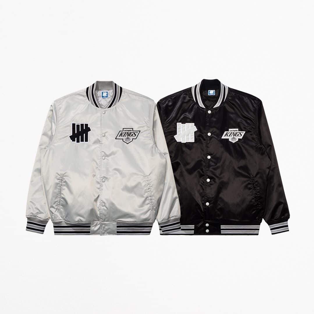 UNDFTDのインスタグラム：「UNDEFEATED x LA Kings  The UNDEFEATED x LA Kings Satin Varsity Jacket is made from 100% nylon satin with a taffeta lining and lightweight fill, and features a striped rib collar, cuffs and waistband, along with an embroidered ‘5-strike’ icon and LA Kings logo on the chest. Available in Grey and Black.   Available Monday, 11/6, exclusively at 11am at UNDEFEATED La Brea, Silver Lake, Santa Monica, Glendale and 8am PST at Undefeated.com」