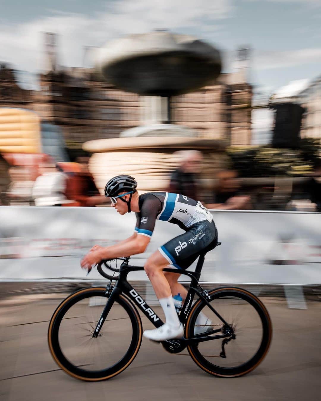 Fujifilm UKのインスタグラム：「Cycling in action 🚴   "Taken at one of British Cycling's grassroots events in Sheffield, UK. Competitors race around a short and narrow course comprising of city pavements, roads, and old cobble streets to get to the front of the pack and lap slower racers.  "The busy crowds and narrow nature of the course meant composition options were limited when shooting the event, so I decided a more creative approach would suit the subject better, shooting with a wider lens at 1/60 while panning with the rider to keep him sharp in the centre of the frame while blurring the motion of the background.   The aim was to give the viewer of my image a better feeling of what it was like to see the riders blaze past in such confined space."   📸: @ipsmith   #FUJIFILMXT3 XF16mmF2.8 R WR f/11, ISO 160, 1/60 sec.」