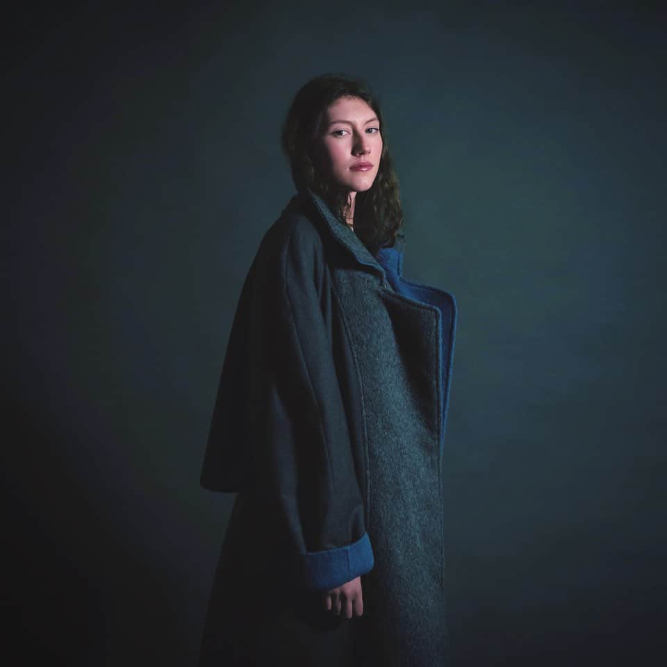 ジャンポールノットのインスタグラム：「Belgian Sky  Grey Blue Alice wears a reversible maxi coat in baby alpaca one side grey other side blue  Available at KNOTT HOUSE   #belguimdesign #minimaldesign #wbdm #madetoshare #madetolast #babyalpaca #bluegrey #greyblue」