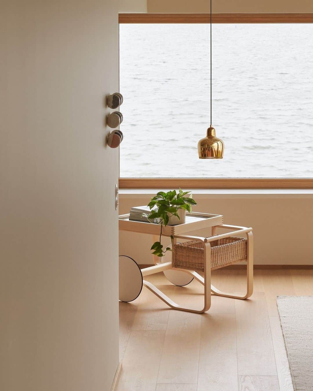 Artekのインスタグラム：「A dreamy view by the sea 🌊⁠ ⁠ Tea Trolley 900 and Pendant Light A330s "Golden Bell" feature in this wonderful image.」