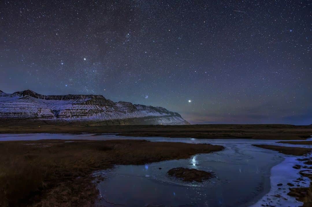 KAGAYAのインスタグラム：「フィヨルドの山の向こうに、木星とすばるがそろって昇りました。 原野の池も凍りはじめた、冬の始まりの夜です。 （先日、アイスランドにて撮影） 今日もお疲れさまでした。  #星空 #Iceland #アイスランド #sonyalpha #α7rv」