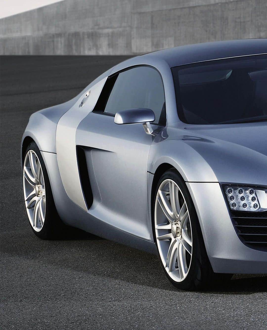 Audiのインスタグラム：「The concept that started it all. The 2003 Le Mans quattro concept car debuted at the Frankfurt Motor Show. Designed by Frank Lamberty, it became an instant hit thanks to its flat muscular lines, and iconic side blades.」