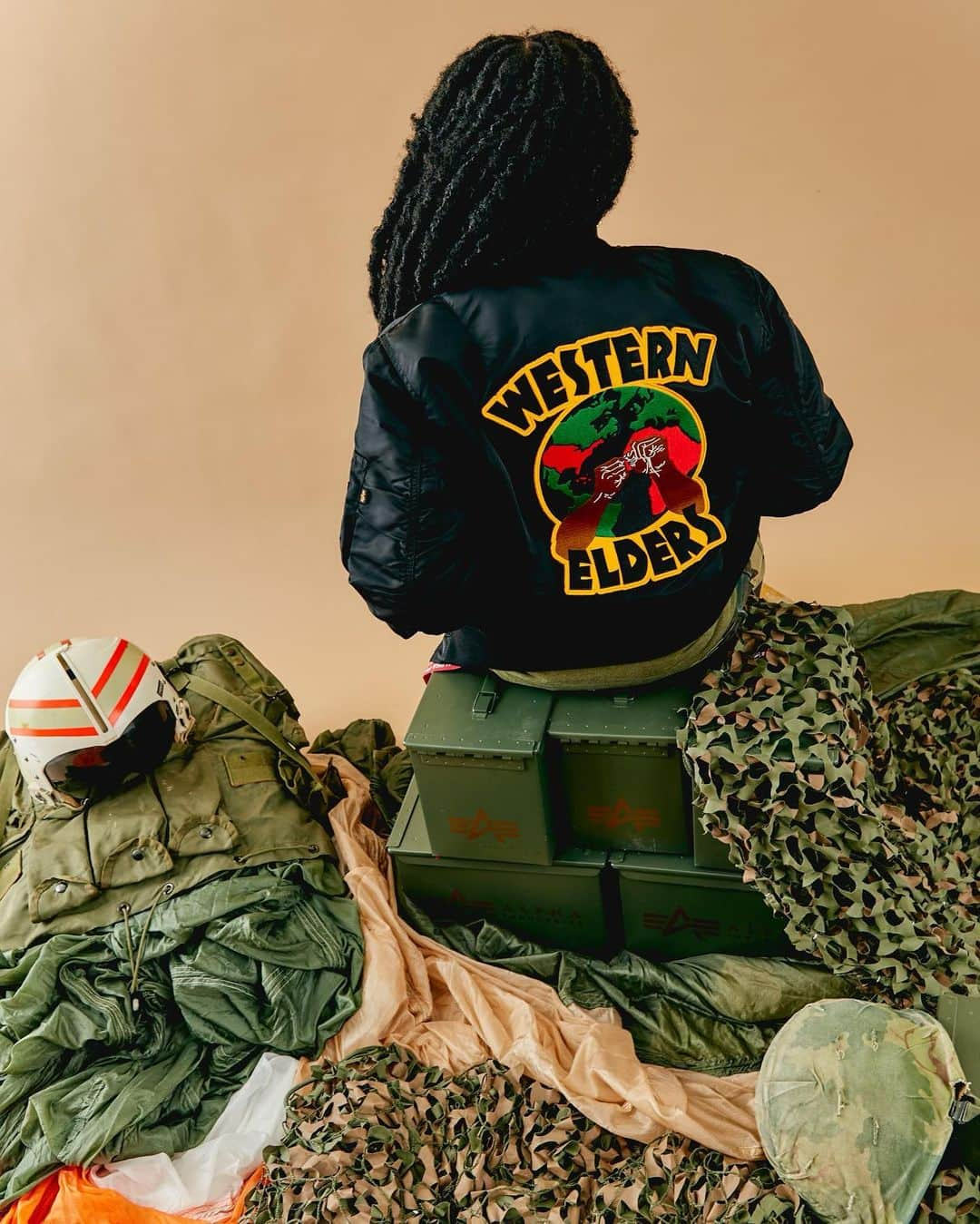 のインスタグラム：「Western Elders has collaborated with @alphaindustries to tell the story of the Brothas and Sistas that defend our land and people across the African Diaspora.  "I got a letter from the government the other day - I opened and read it, it said they were suckers" More than a Public Enemy lyric, this was the sentiment of an often overlooked people forced to fight for someone else's cause. But even in the turmoil of war we found something beautiful. Our principles and values held us together and this war of theirs became our time to show the world not only our Dignity and Pride but that we will always stand for what's right no matter where we are. These Brothas and Sistas instilled that camaraderie and a desire to get closer to our family Stateside, in the Caribbean, and on the Continent. They gave birth to this energy in us and Western Elders is here to keep it alive, Welcome to the African Diaspora Defense Group✊🏾❤️🖤💚  NYC exclusive release 11/11 Online release 11/15  📸@kneegash」