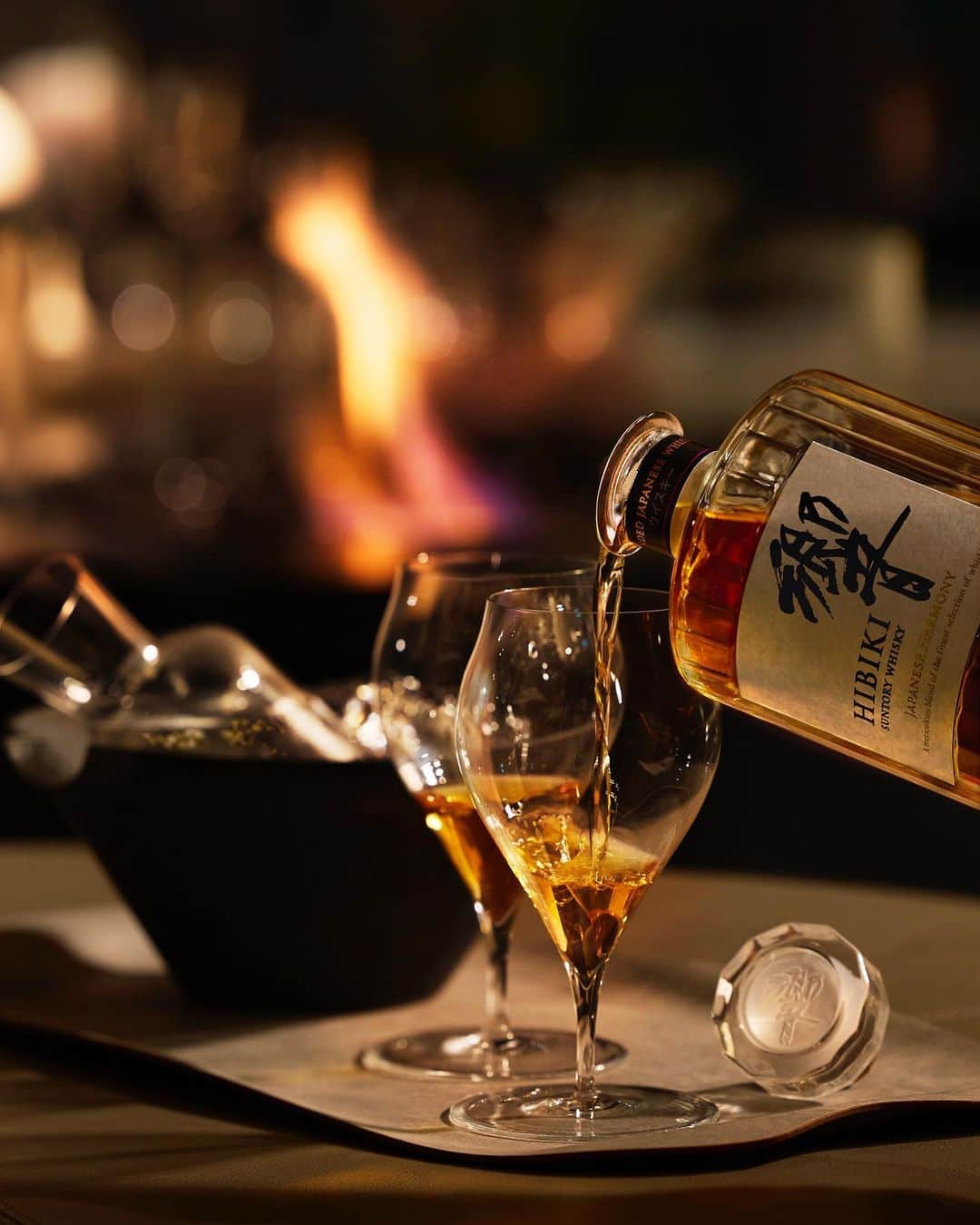 響 | SUNTORY WHISKY HIBIKIのインスタグラム：「. HIBIKI TIME ~二十四節気・立冬~  艶やかな琥珀の封を解く。 Unseal the elegant bottle of enchanting amber.  #hibiki #響 #hibiki_time #二十四節気 #24seasons #立冬 #ritto #withnature #旅 #trip #グラス #glass #ペアグラス #pairglass #暖炉 #fireplace」