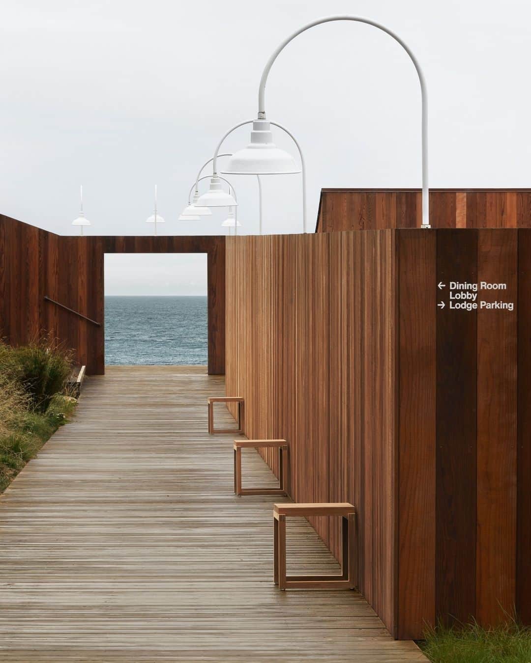 フリッツハンセンのインスタグラム：「Sea Ranch Lodge, California⁠ ⁠ Created as an architectural experiment in the 1960s, Sea Ranch Lodge is now a symbol of sustainable design on the California coast. ⁠ ⁠ A recent outdoor transformation took place with pieces from the Skagerak Collection chosen for their minimalist Nordic design and inspiration drawn from nature. ⁠ ⁠ The wooden benches and stools create an inviting outdoor haven for guests and residents.⁠ ⁠ Skagerak Collection pieces pictured: ⁠ -	Banco Bench designed by Hugo Passos⁠ -	Between Lines Deck Chairs designed by Stine Weigelt⁠ -	Cutter Bench & Stool designed by Niels Hvass⁠ ⁠ Explore the full story of Sea Ranch Lodge via the link in bio. ⁠」