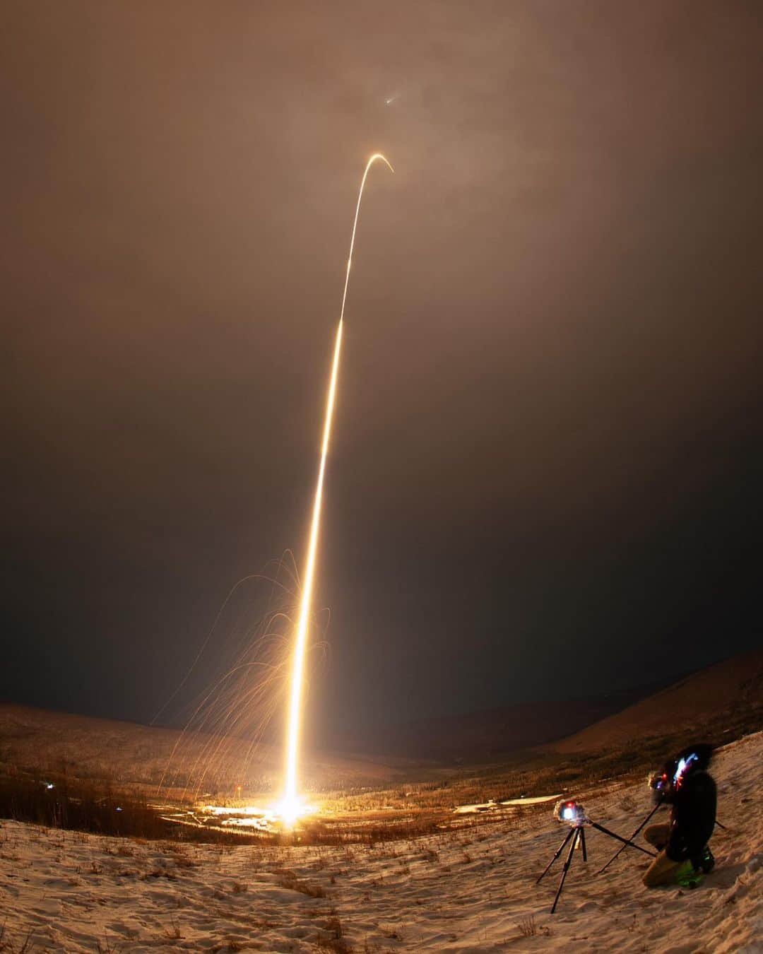 NASAさんのインスタグラム写真 - (NASAInstagram)「Twice the launches, twice the fun! Two sounding rockets launched from Poker Flat Research Range in Fairbanks, Alaska this week. Yesterday's rocket carried @nasagoddard's DISSIPATION mission into an aurora to study understand how auroras heat the atmosphere and cause high-altitude winds.  Image 1: A long-exposure photograph of a sounding rocket launching into a night sky highlighted by aurora. The sounding rocket is a bright white streak, leaving from a snow-covered ground and moving from bottom left to upper right. A small break in the streak represents the first stage of the rocket burning out and the second stage igniting. A soft, green aurora frames the edges of the image, with many white stars speckled through the black sky. A bright green line toward the top of the frame is a lidar beam. A fisheye lens was used for the photograph, creating a curve for the ground and lidar beam.  Image 2:  A long-exposure photograph of a sounding rocket launching into a cloudy night sky. The sounding rocket is a bright white streak, leaving from a snow-covered ground and moving from bottom left to upper right. The ground is snow covered in the bottom of the frame with and at the right of the frame is a photographer setting up two camera tripods.  Photo Credit: NASA/Lee Wingfield  #Aurora #NASA #SoundingRocket #RocketLaunch」11月10日 5時34分 - nasagoddard