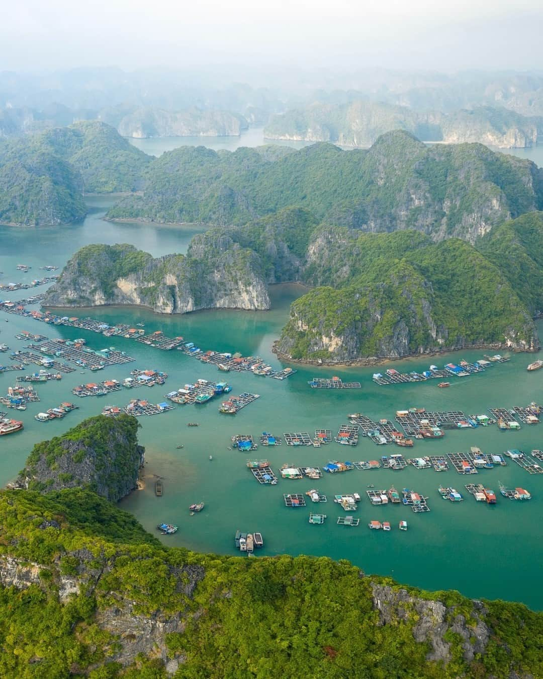 National Geographic Travelさんのインスタグラム写真 - (National Geographic TravelInstagram)「Photo by @tobyharriman | This traditional fishing village in Lan Ha Bay, Vietnam, floats atop emerald waters among lush limestone karst formations. Villagers depend on the sea for survival and make a living from fishing, aquaculture, and tourism. It looks like paradise, but their unique way of life is threatened by wastewater and plastic pollution, unsustainable tourist activities, and climate change. Follow @tobyharriman for more. #vietnam #aerial」11月12日 2時30分 - natgeotravel