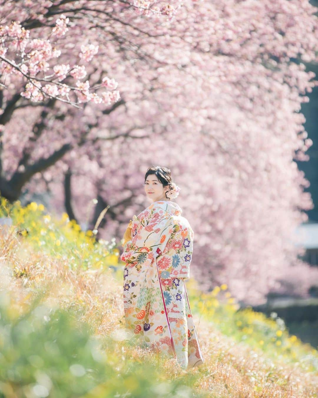 スタジオAQUA 横浜店のインスタグラム：「毎年大好評を頂いております河津桜プラン‼️ 2024年度のご予約はもう始まっております✨  この写真のように、満開の桜を背景いっぱいに写せるのも魅力の一つになっております😊  文字通り"華やか🌸"な前撮りをご検討中の方は、お近くのスタジオアクアにてお問い合わせくださいませ！  ＃撮る結婚式 @studioaqua_fuji @studiosola_hokkaido @decollte_wedding @decollte_weddingphoto @d_weddingphoto_jp #ブライダルフォト #前撮り #ウェディング #花嫁diy #プレ花嫁 #結婚式準備 #結婚写真 #チェリフォト #preweddingphoto #2022冬婚 #カップルフォト倶楽部 #何気ない瞬間を残したい #ナチュラルウェディング #mywedding #カップルフォト #結婚」