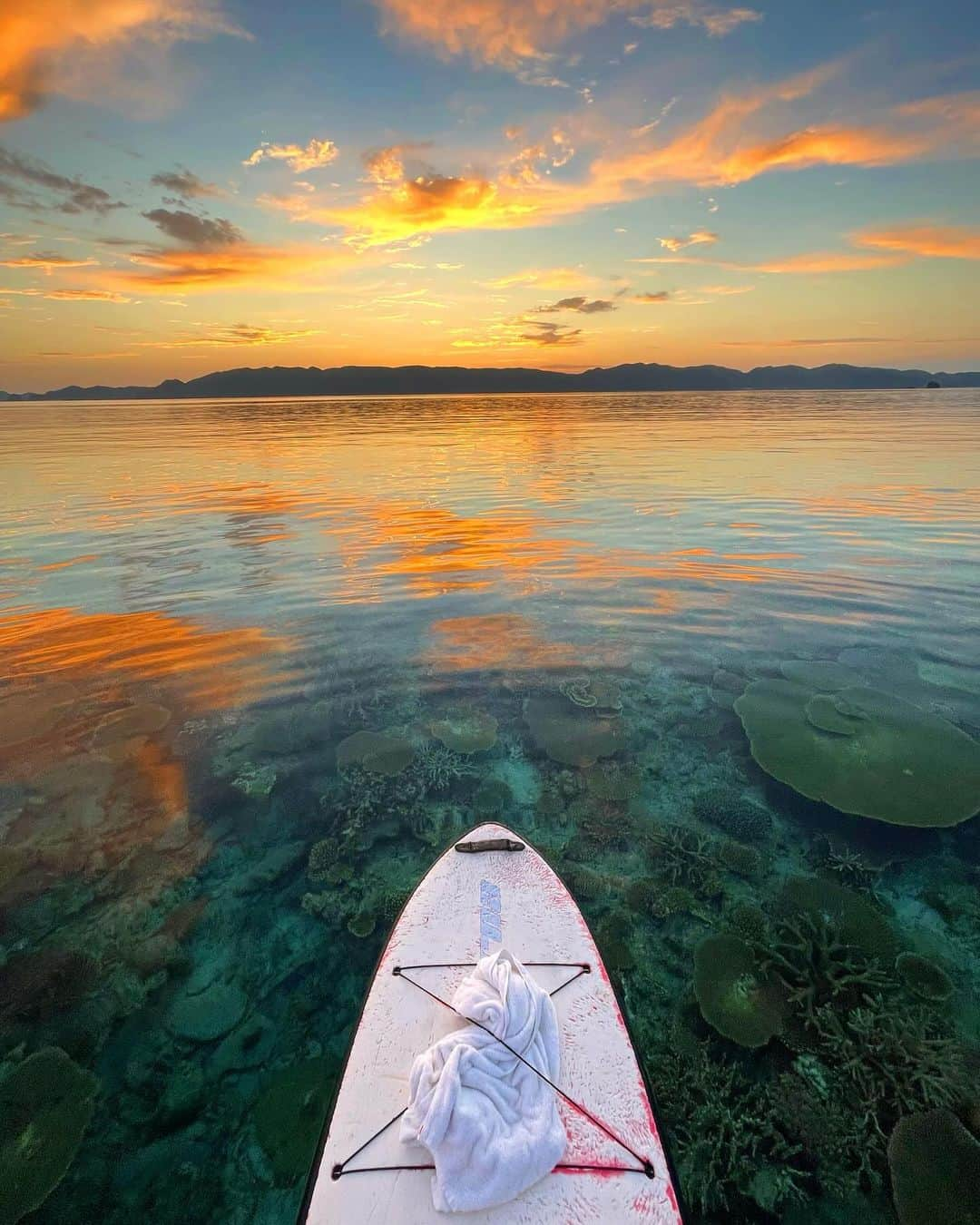 NAHOさんのインスタグラム写真 - (NAHOInstagram)「🧡 #sunrisesup #sunrise 🧡 . . 古様味beachからシルまで見渡す限り ベタ凪、つるつる、きらきら✨ 優しい空気、朝焼けの色、圧倒的大自然✨ この日の朝は寒くもなく暑くもない、 心地いい空気とキラキラ朝日っ🌅🎶 お空の雲が幻想的で自分達以外だれもいなくて、 この景色をずっと独り占めさせていただきました🙏♡ . . 今年はサンライズサップもサンセットサップも いっぱいできたなっ🫶🏼🌿 大好きな海のある生活🏝️大自然に感謝の日々🙏 毎日が心地良い心に残るなほの島暮らし♡ . . . #NAHO #nature #photo #photography #okinawa #zamami #zamamiisland #sup #沖縄 #座間味 #座間味島 #朝日 #朝焼け空 #自然 #離島 #島暮らし #沖縄移住 #海が好き #海のある生活 #海 #写真で伝えたい私の世界」11月12日 19時27分 - naho25__kai_noa