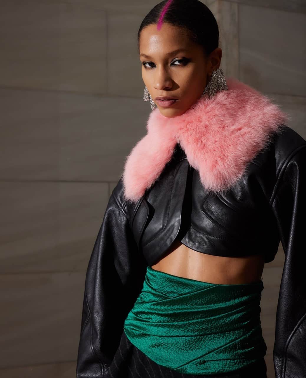 プラバルグルンのインスタグラム：「Luxe Layers⁠ ⁠ Black Leather Cropped Jacket with Repurposed Pink Shearling Collar with Emerald Hammered Satin Cummberbund and Black Pinstripe Wool Asymmetric Skirt from the Fall Winter 2023 collection⁠ ⁠ Photo by @egandrewphotos」