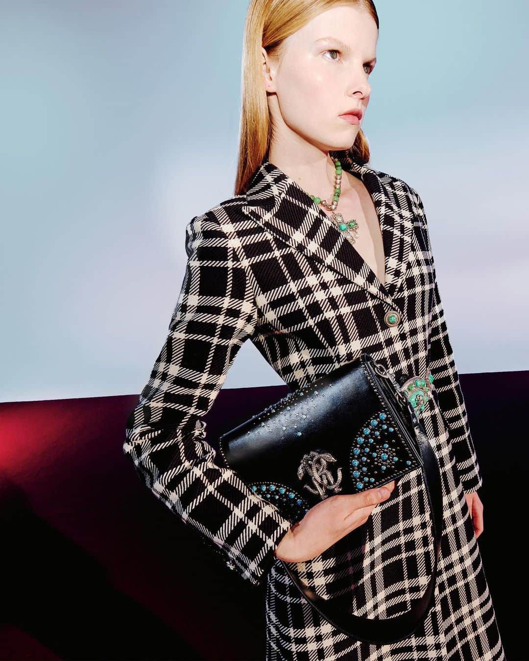 ロベルトカバリのインスタグラム：「Classics, redefined. Strong lines can make a bold statement, just like a black & white coat can take a whole new meaning with a turquoise jewel button. Take some time off conventions on your next rendez-vous.  Shop #RobertoCavalli at the link in bio and in boutiques worldwide.」