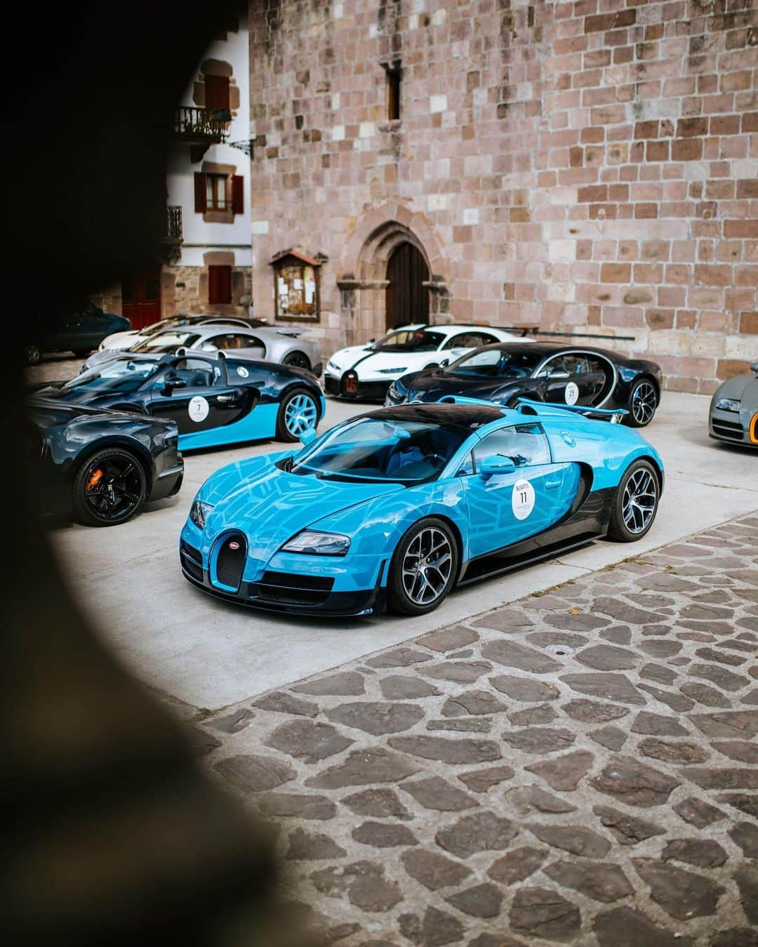 ブガッティのインスタグラム：「The Basque regions – home to one of Europe's oldest and richest cultures – is the starting point to this year’s BUGATTI Grand Tour Europe by @2Fast4You.it.   In the city of Biarritz, revered for its captivating Belle Époque architecture, 29 BUGATTI owners with their Molsheim-created hyper sports cars – featuring an array of VEYRON 16.4, CHIRON and DIVO models – embarked upon a mesmerizing adventure; a carefully curated BUGATTI driving experience from the French Atlantic coast across the Pyrenees to reach the Basque Country in Spain.   #BUGATTI #BUGATTIGrandTour #BUGATTIGrandTourEurope – WLTP: bugatti.link/consumption」